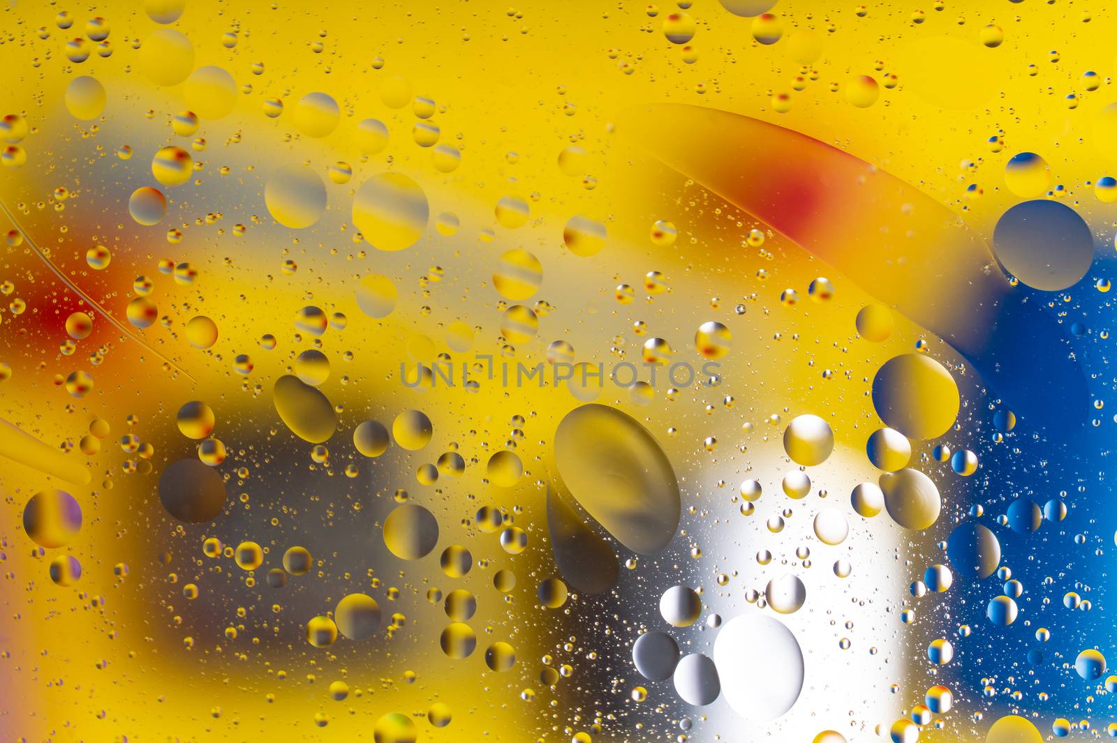 The abstract composition with oil drops in water. Yellow main color.