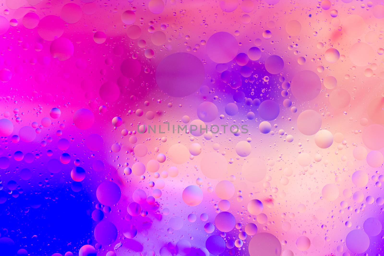 The purple abstract composition with oil drops in water. 