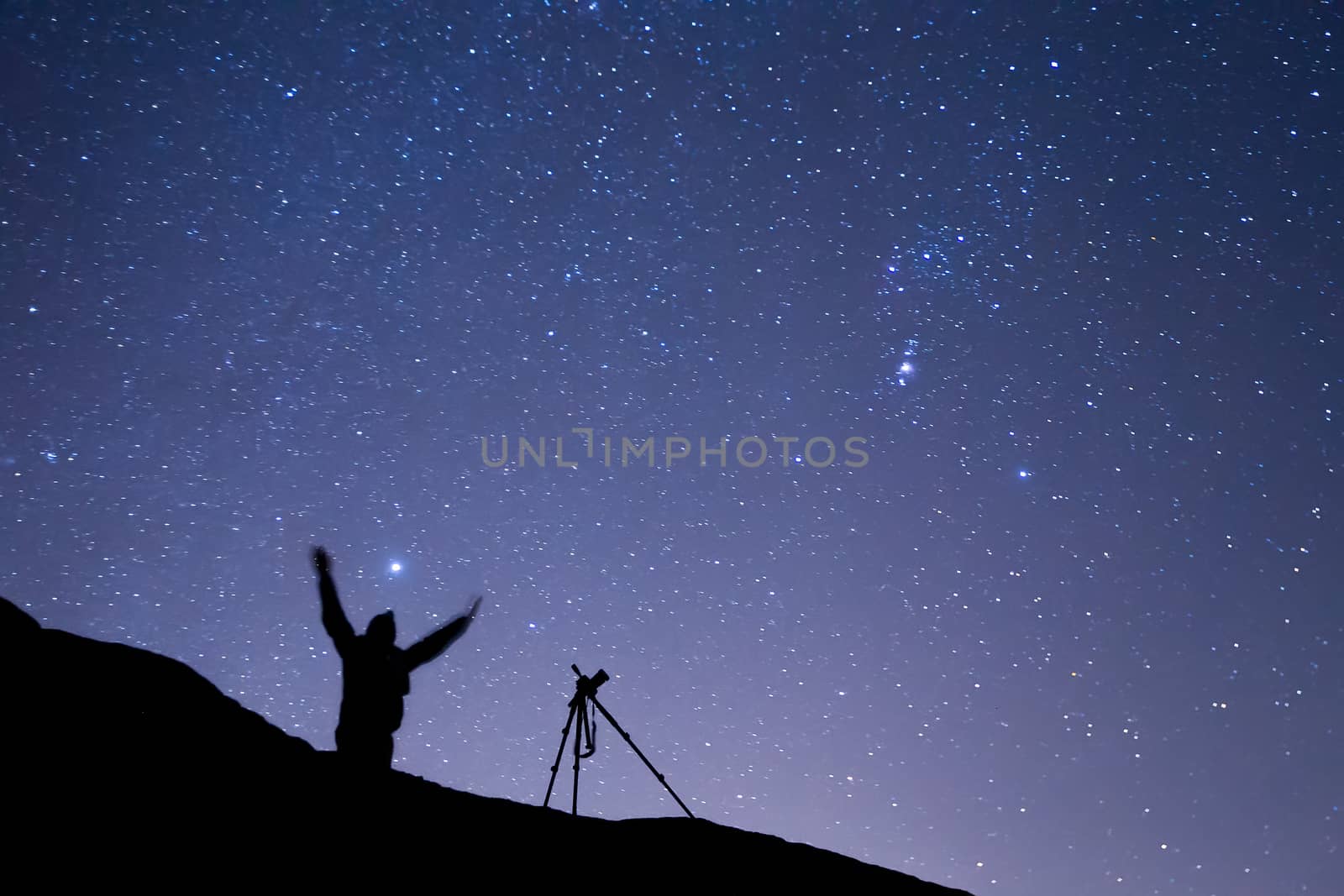 photographer shooting the starry sky seen from Meteora, Greece by ververidis