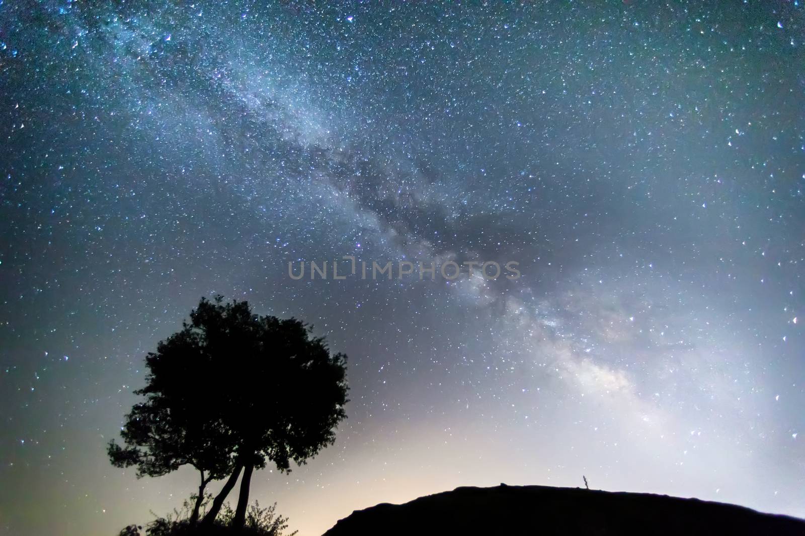 Milky Way over the Meteora, Greece. long exposure; Image contain noise, blur due to slow shutter speed.