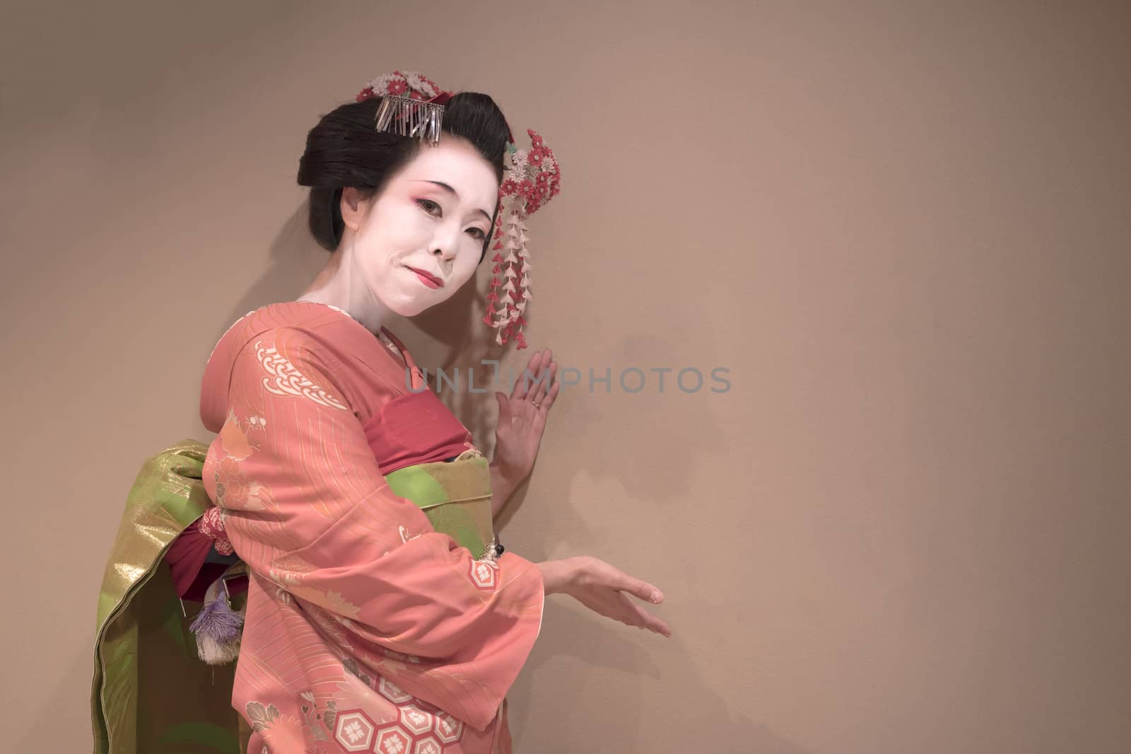 Clipping japanese geisha maiko girl in red kimono coifed hair brooch with patterns of red and white plum blossoms on white background.