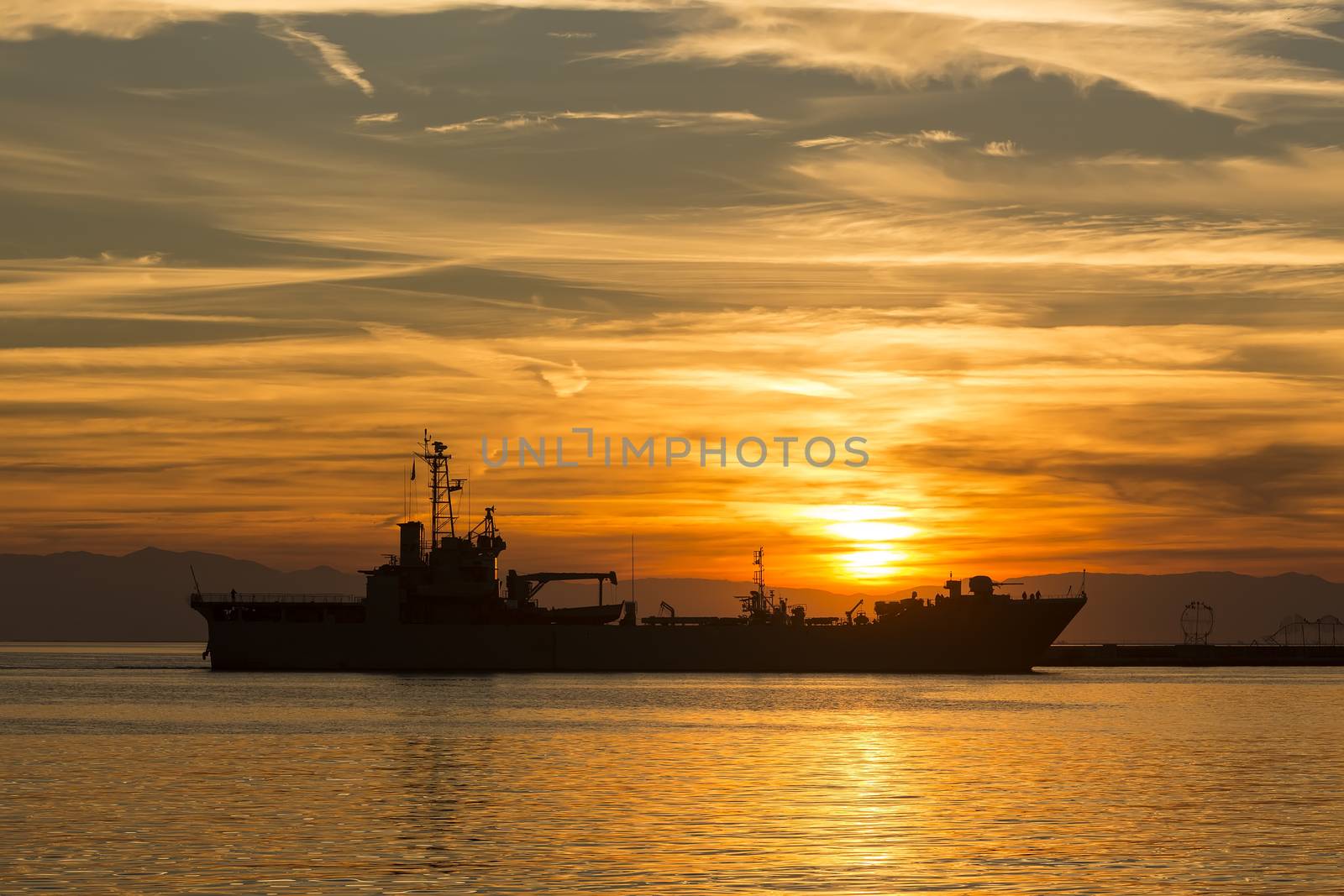 Bulk-carrier ship at sunset in the sea