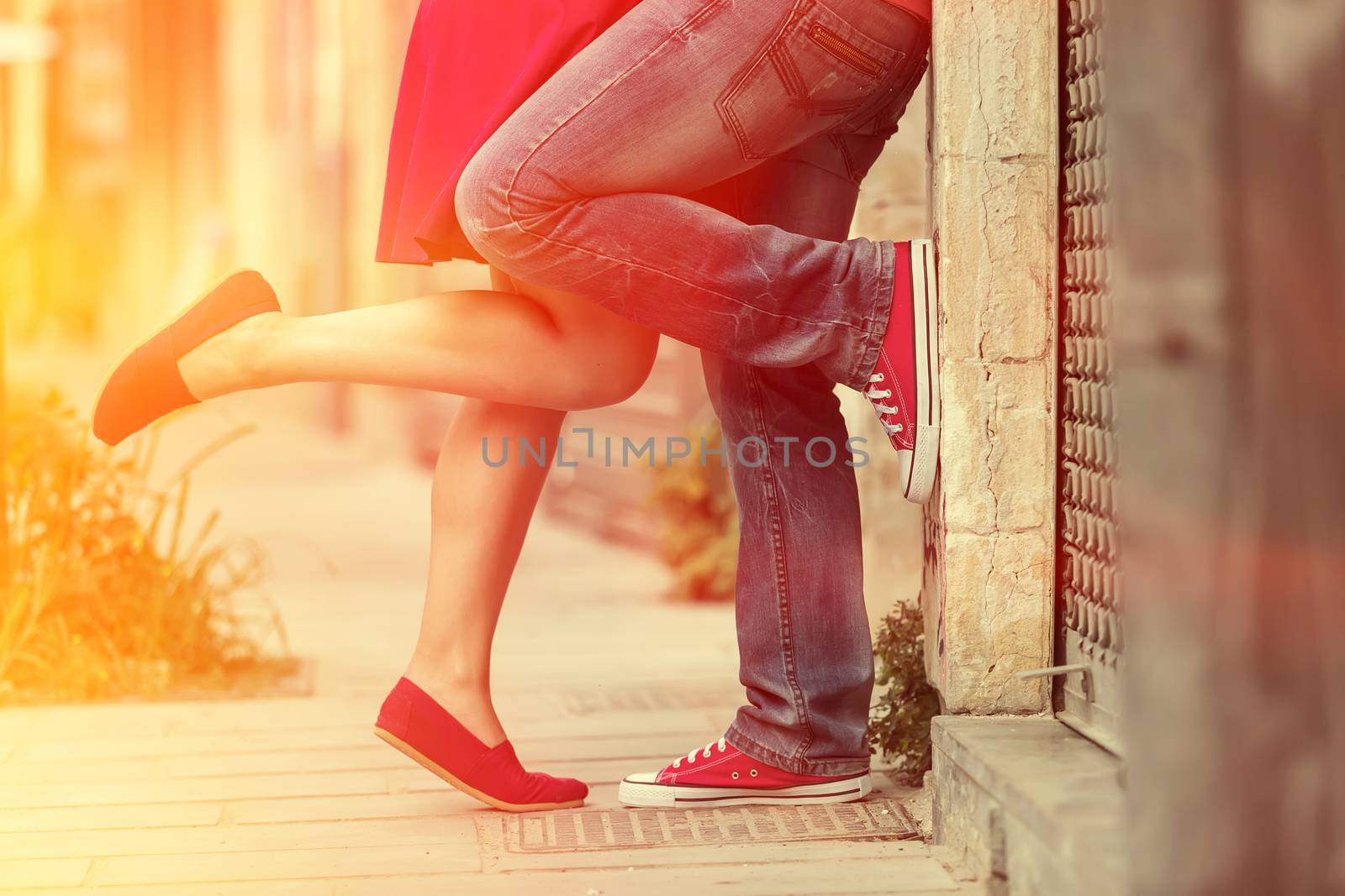 Young couple kissing outdoor. Male and female legs. Cross proces by ververidis