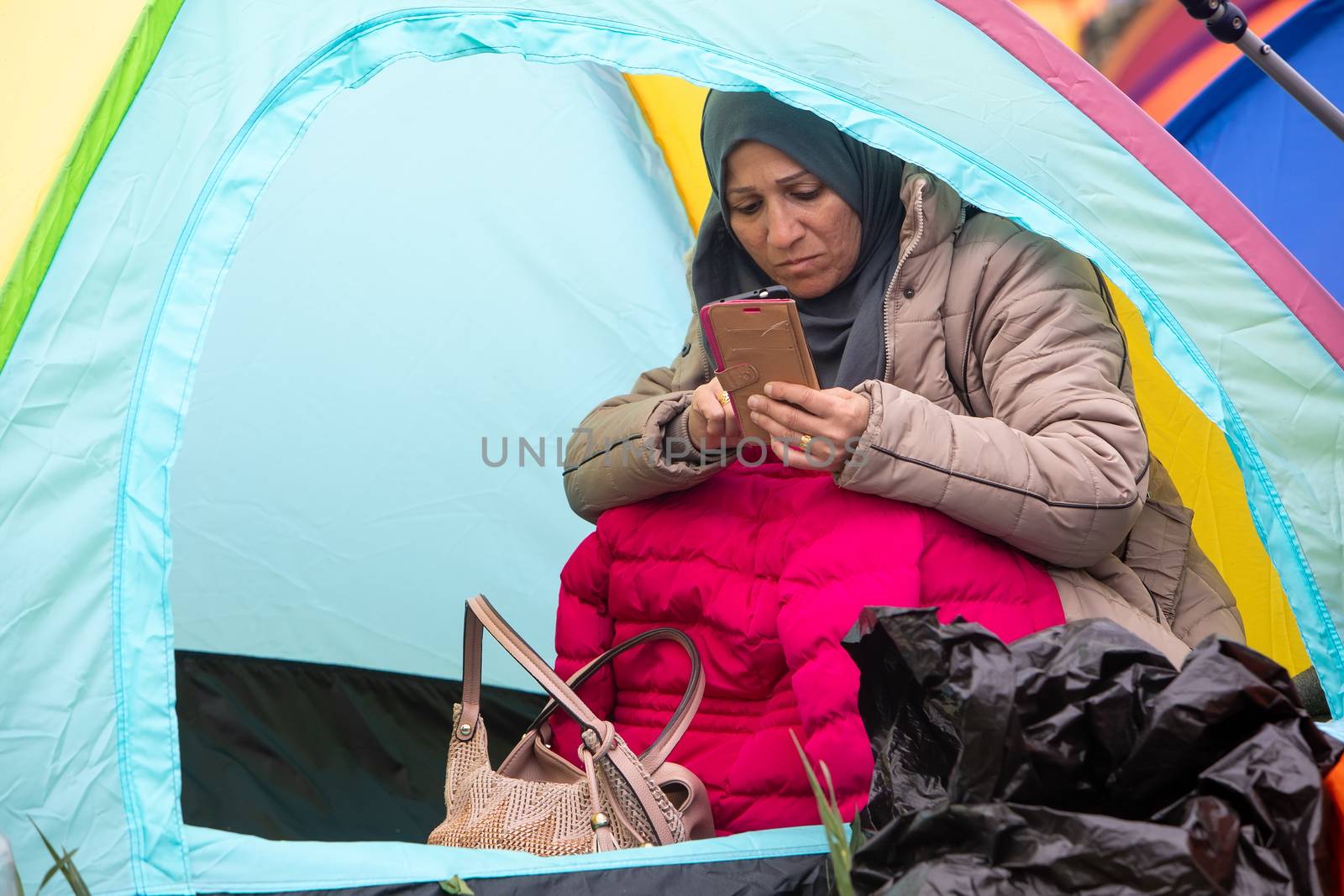 Hundreds of migrants and refugees gathered outside of a refugee by ververidis