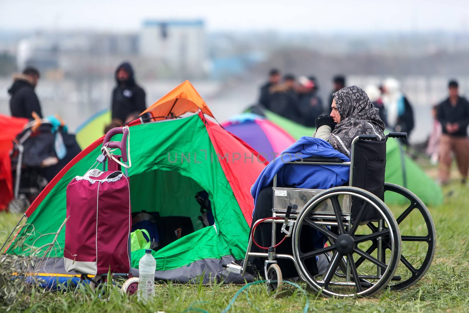 Hundreds of migrants and refugees gathered outside of a refugee by ververidis