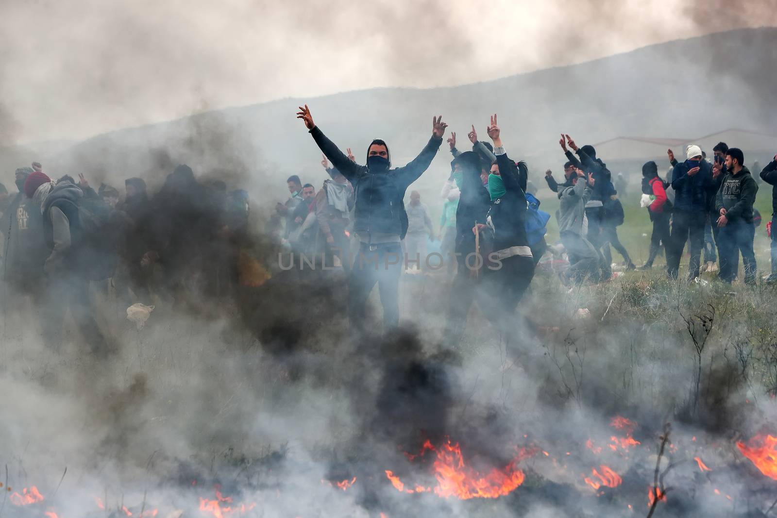 Migrants clashes with Greek riot police outside of a refugee cam by ververidis