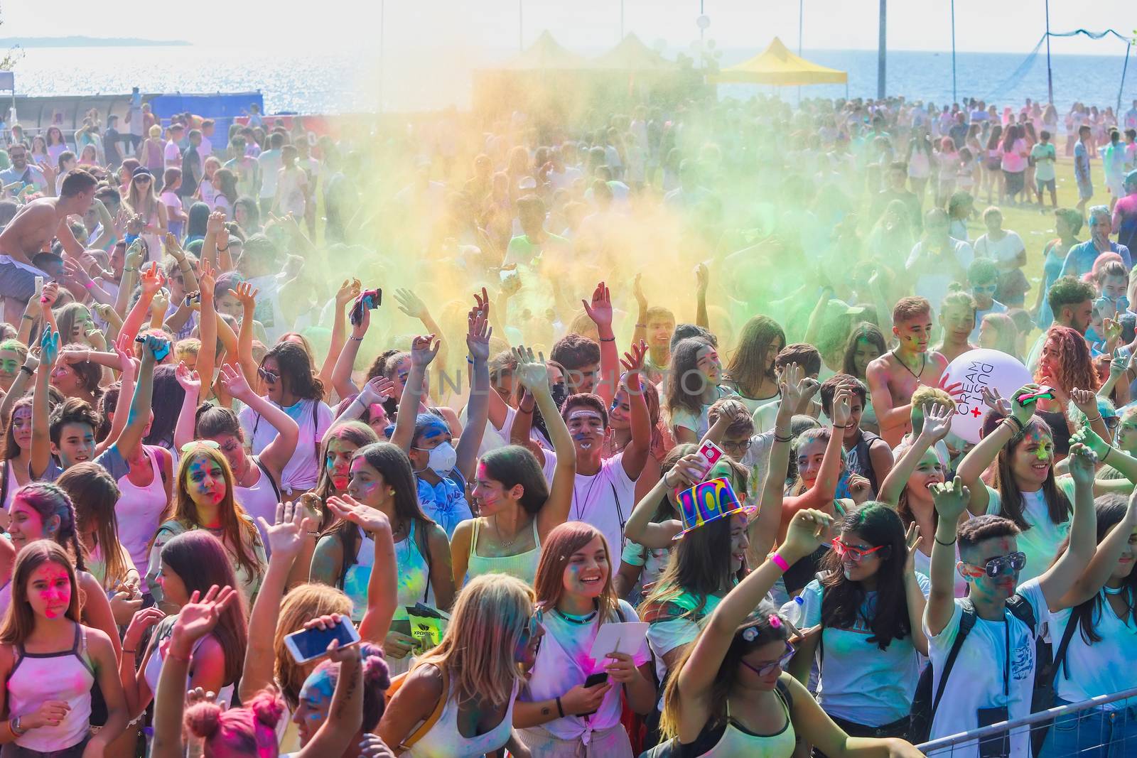 Thessaloniki, Greece - September 2, 2018: Crowds of unidentified people throw colour powder during the "Day of Colours" annual event.