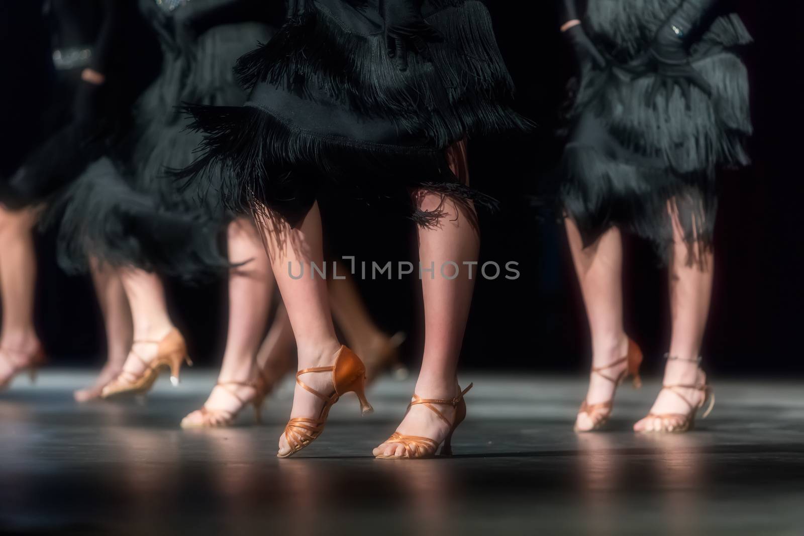 Legs of young dancers on the dance floor 