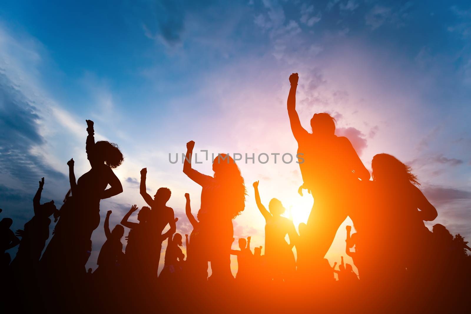 silhouettes of young people dancing