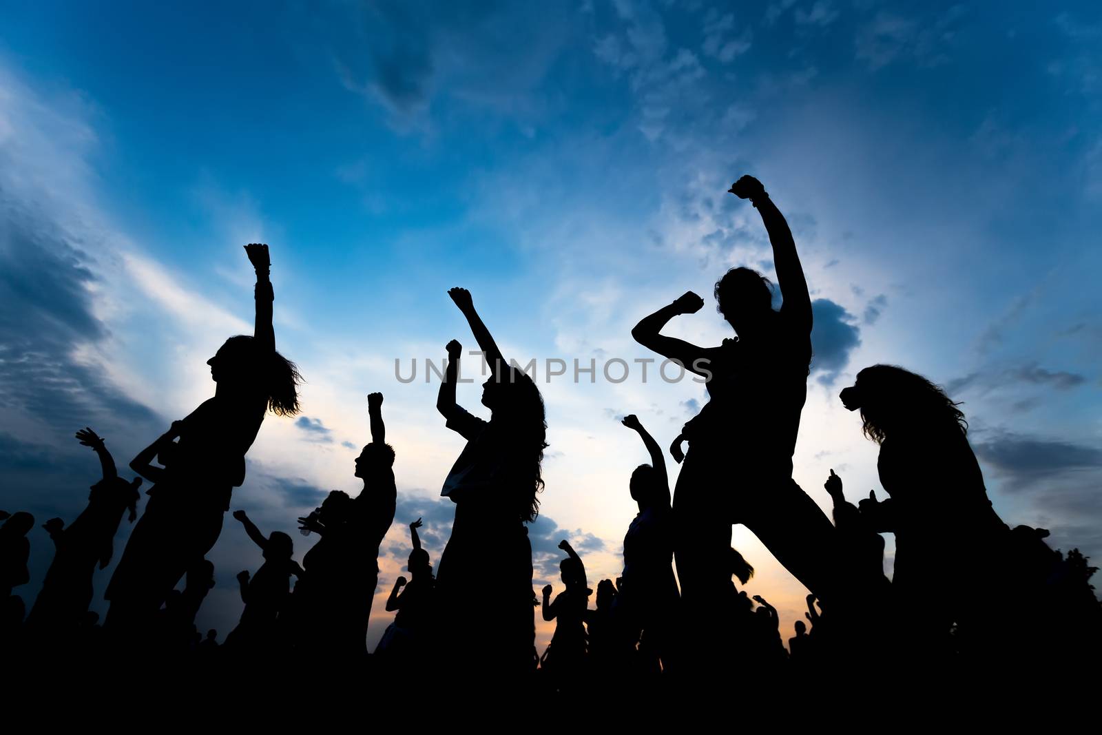 silhouettes of young people dancing by ververidis