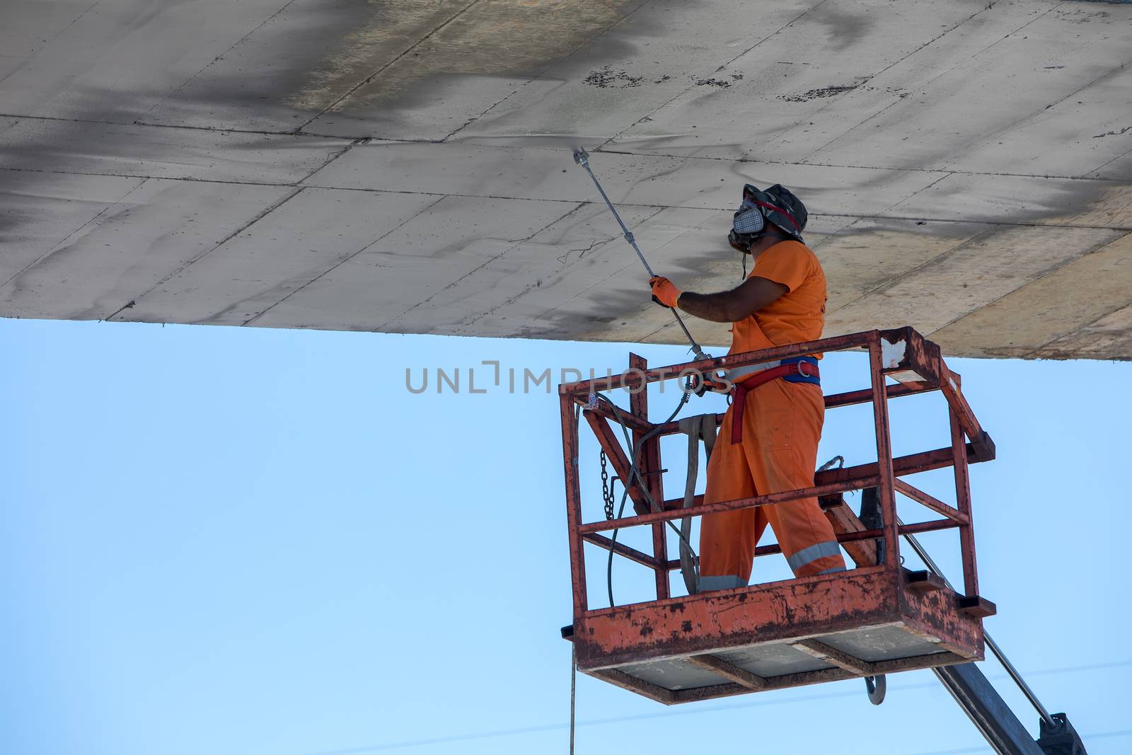 worker on a lifting machine works on the construction by ververidis