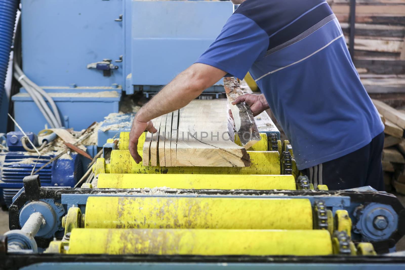 Craftsmen cut a piece of wood at a woodworking factory in Greece by ververidis