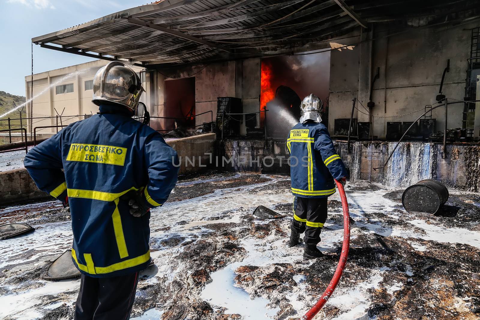 Aspopirgos, Greece - March 28, 2016: Firefighters struggle to extinguish the fire that broke out at a paint factory