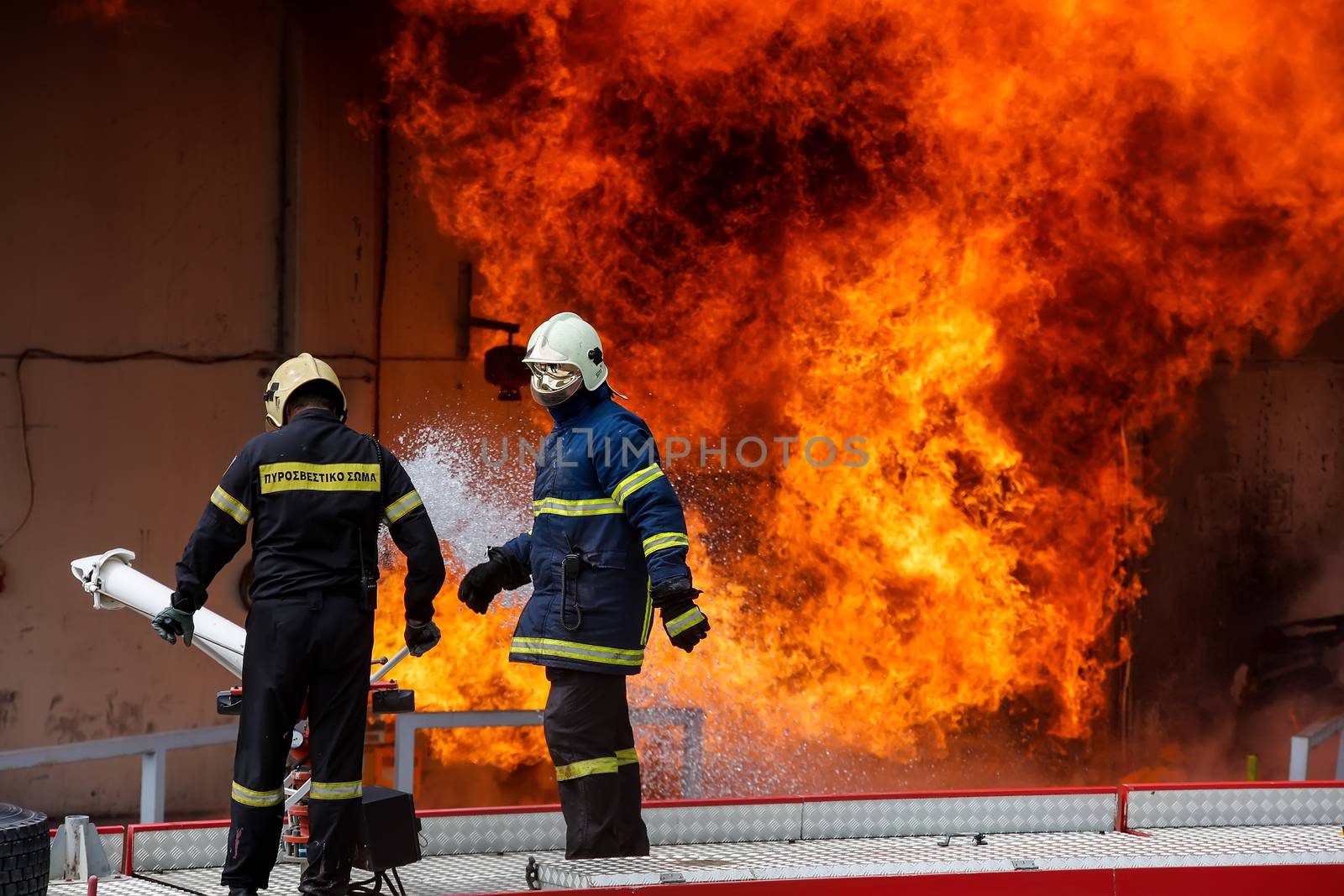 Aspopirgos, Greece - March 28, 2016: Firefighters struggle to extinguish the fire that broke out at a paint factory