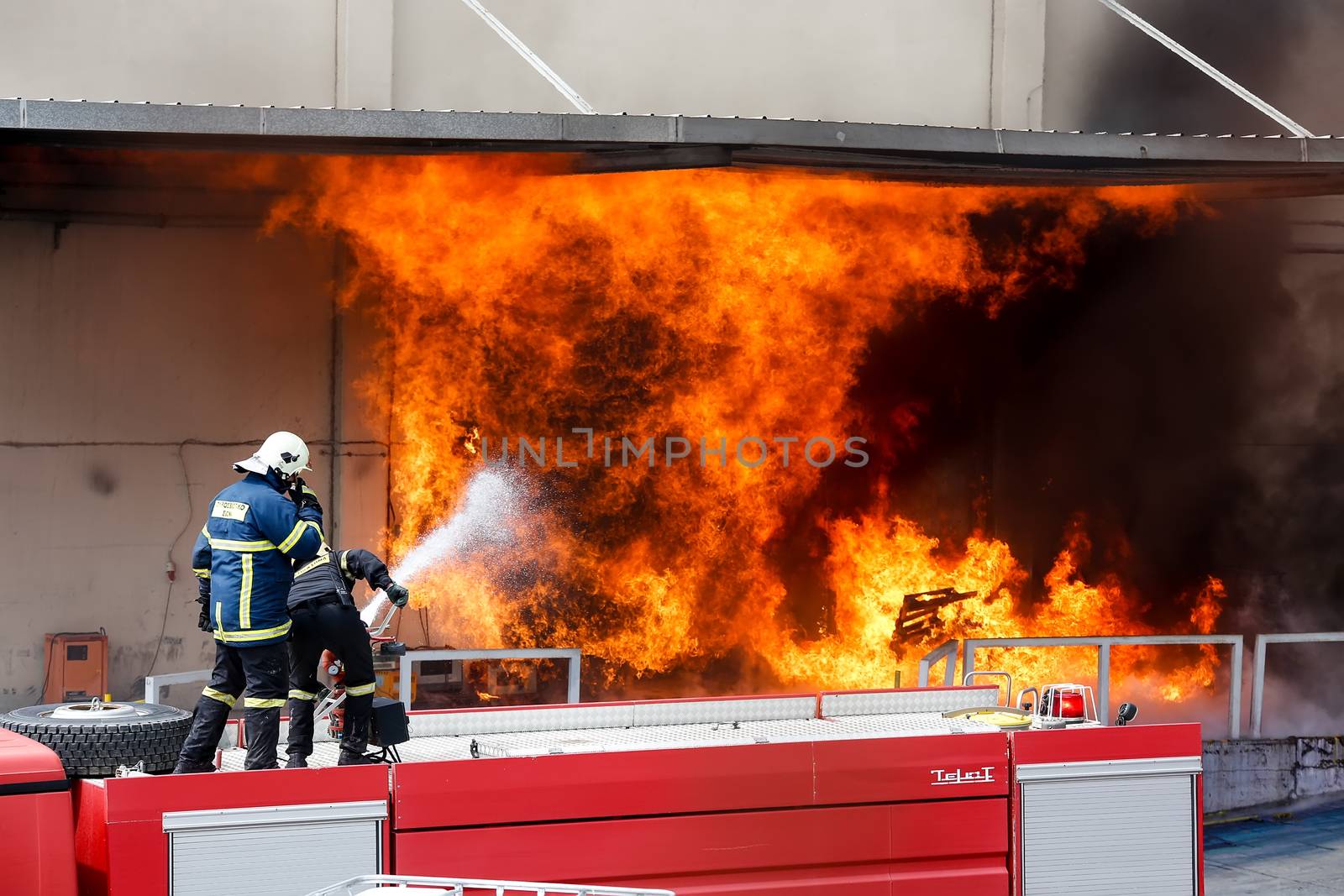 Aspopirgos, Greece - March 28, 2016: Firefighters struggle to extinguish the fire that broke out at a paint factory