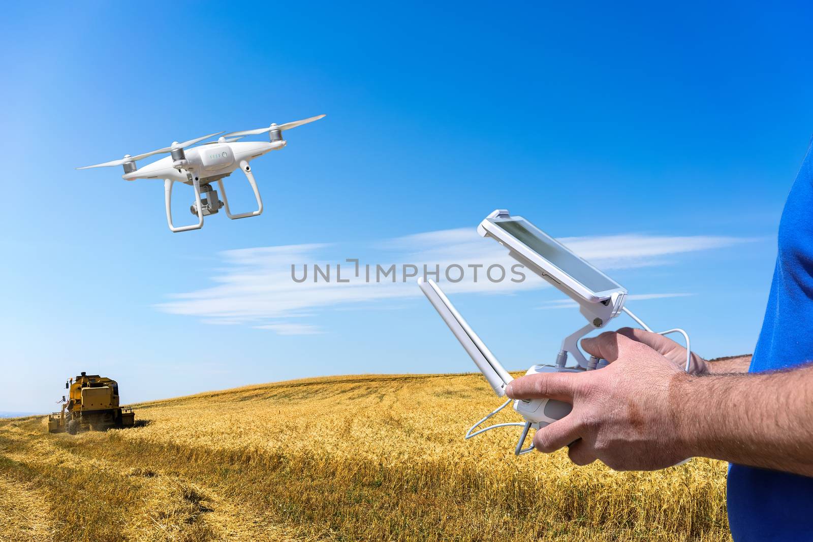 Controlling a remote helicopter drone. Drone flight remote controller in man hands. flying over fields