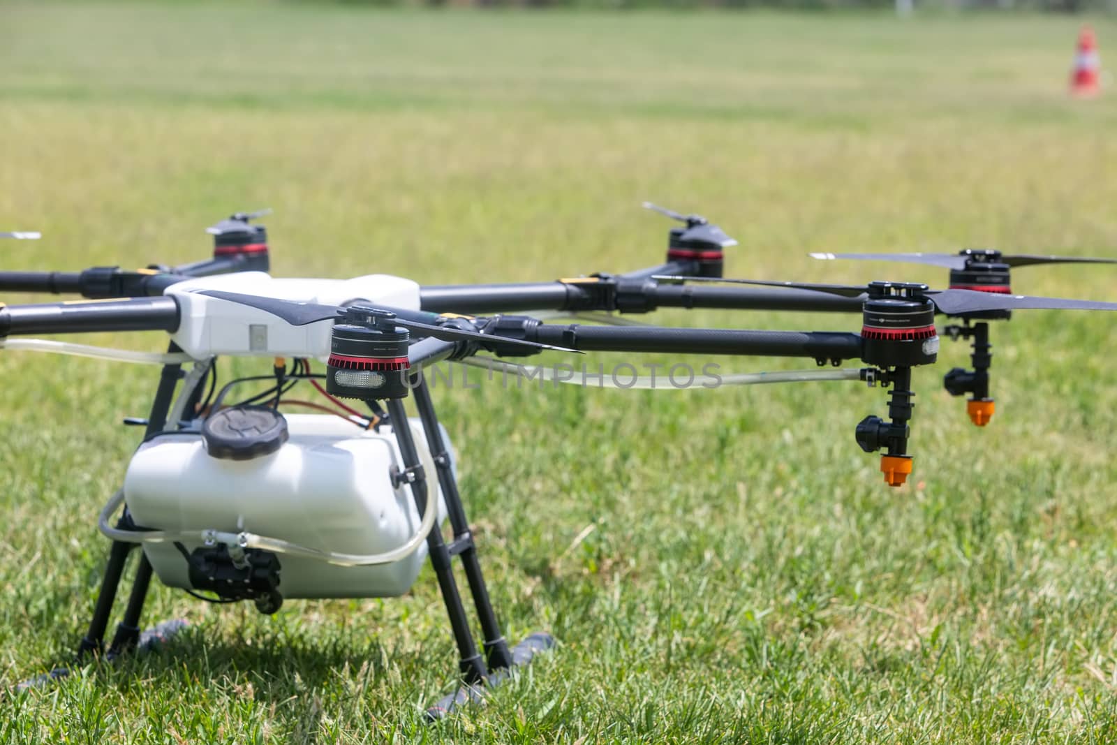 Professional agriculture drone on the green field during pre-fli by ververidis