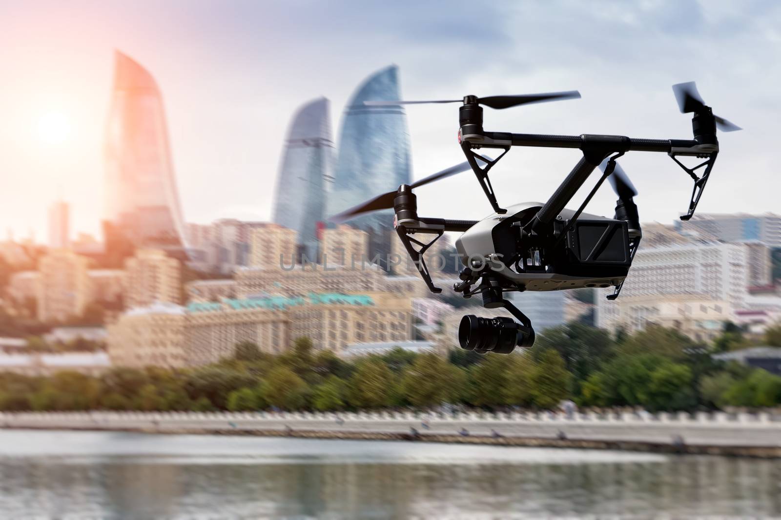 Drone flying over Baku city on blurred background.