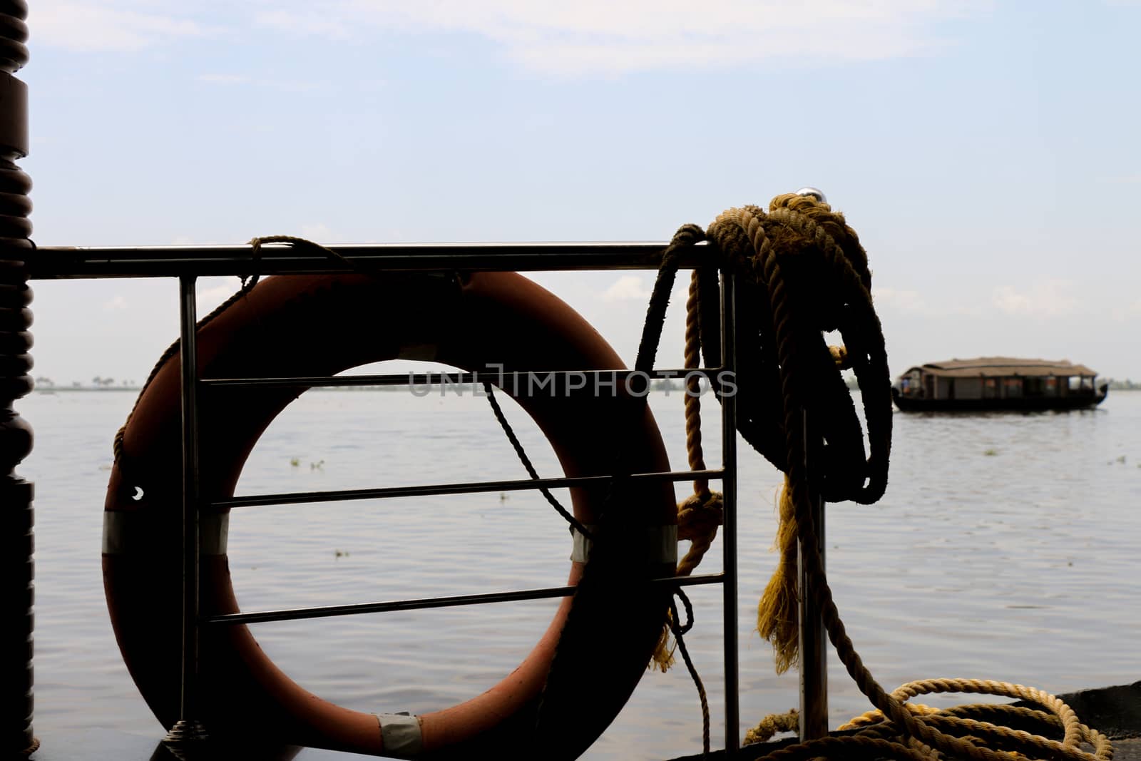 Lifebouy and Rope Silhouette at Dock in a Cloudy day