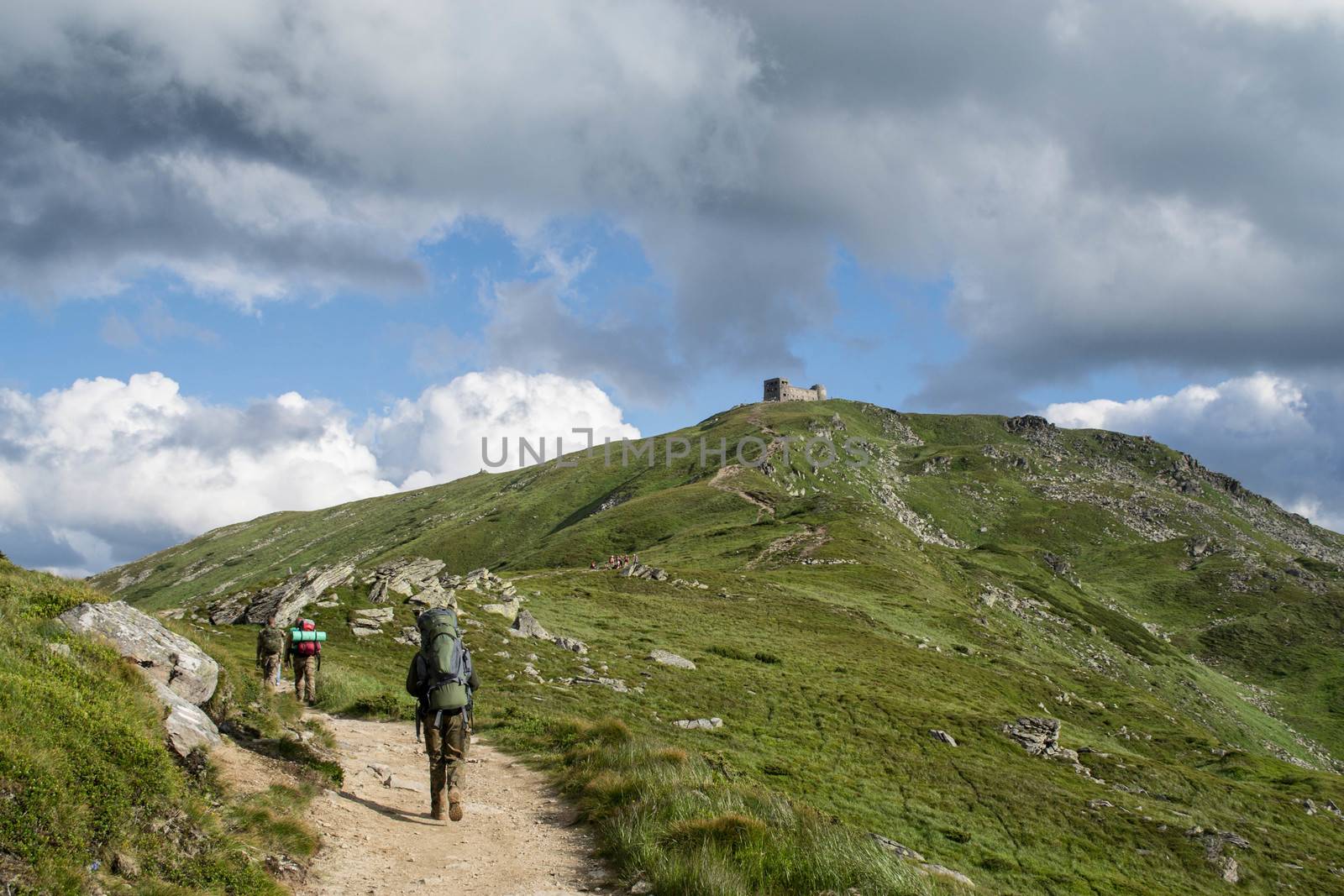 Tourists follow a mountain trail