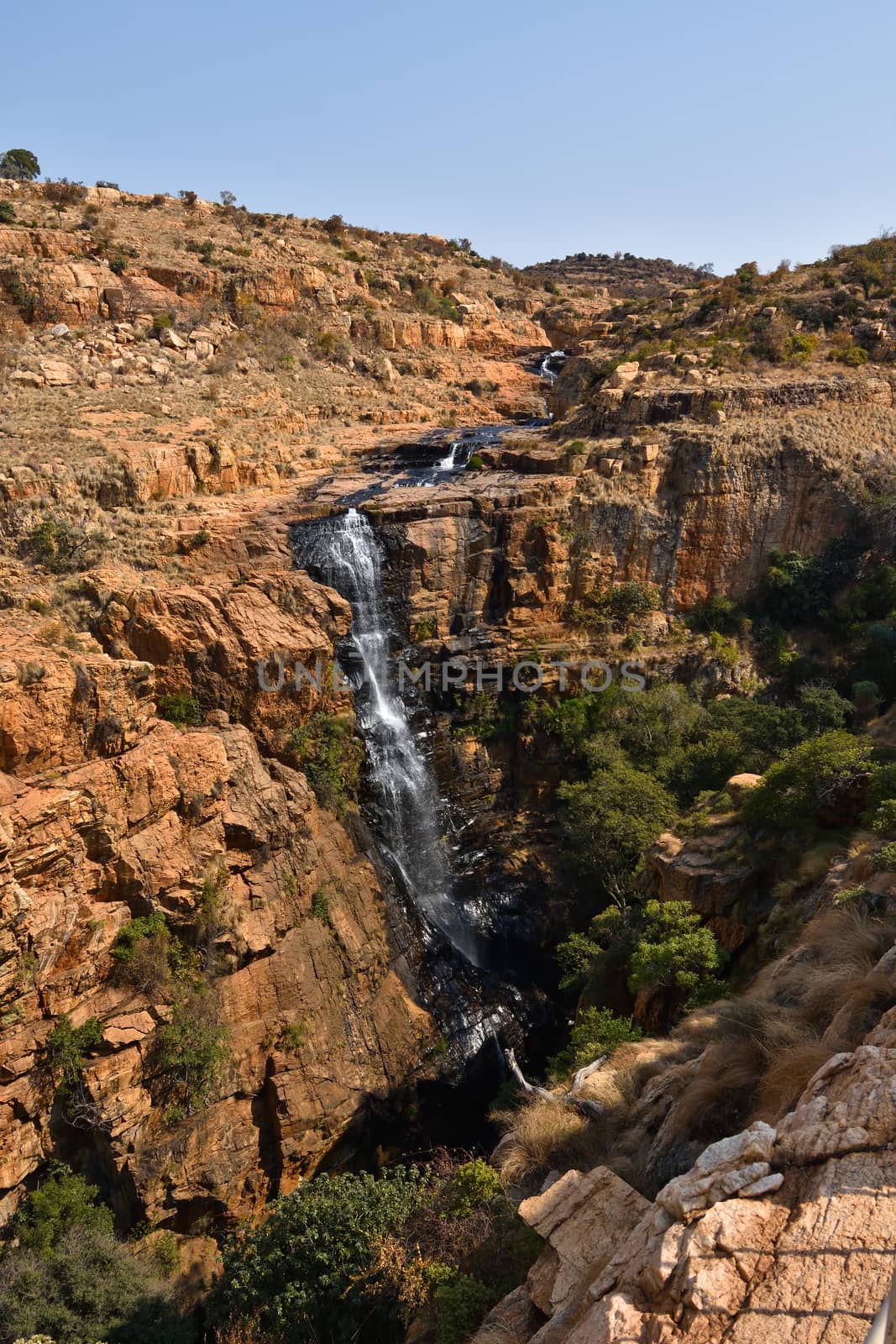 Natural steep cliff waterfall ravine in rocky terrain, Rustenburg, South Africa