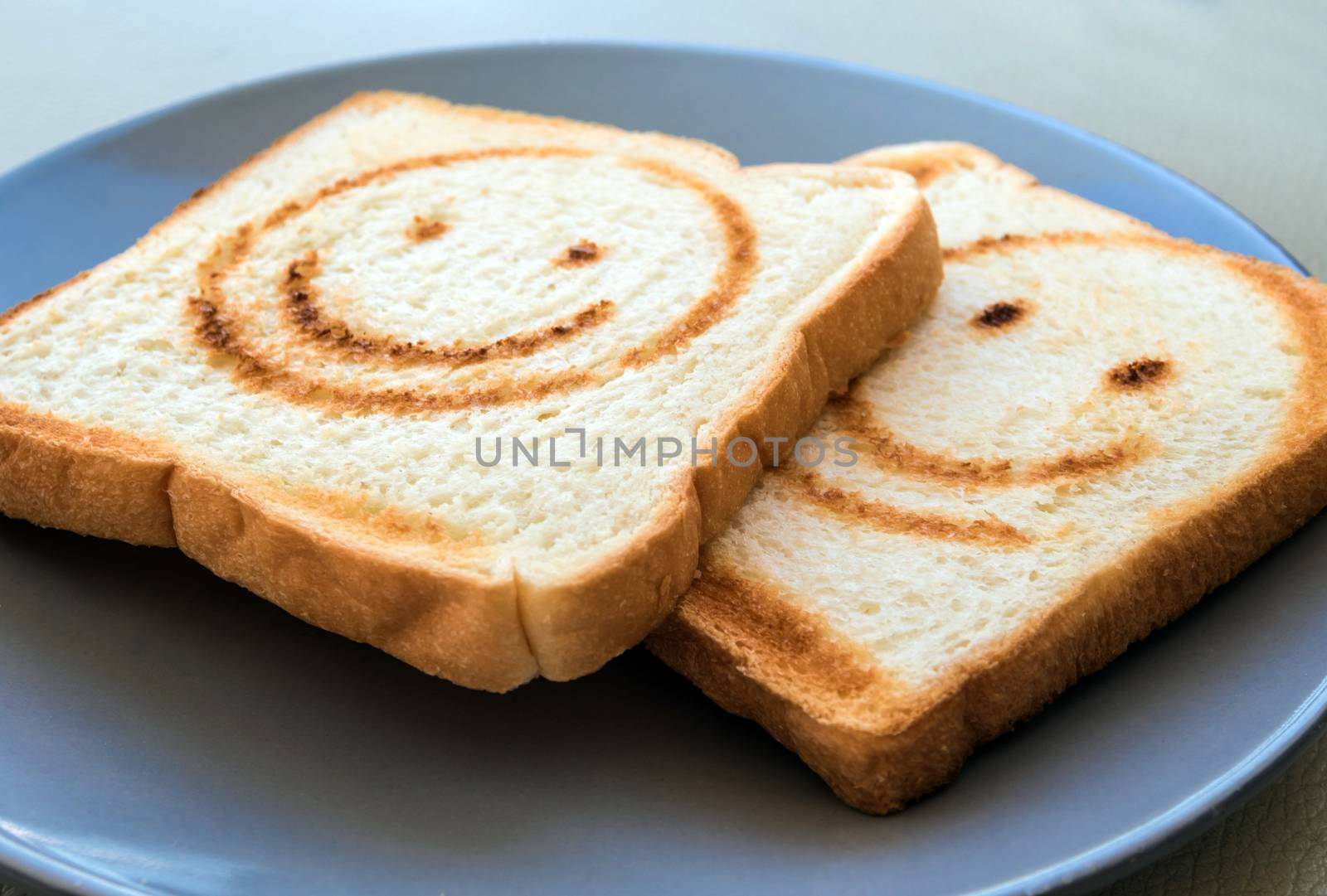 Burning line as happy face on the bread sheet by Satakorn