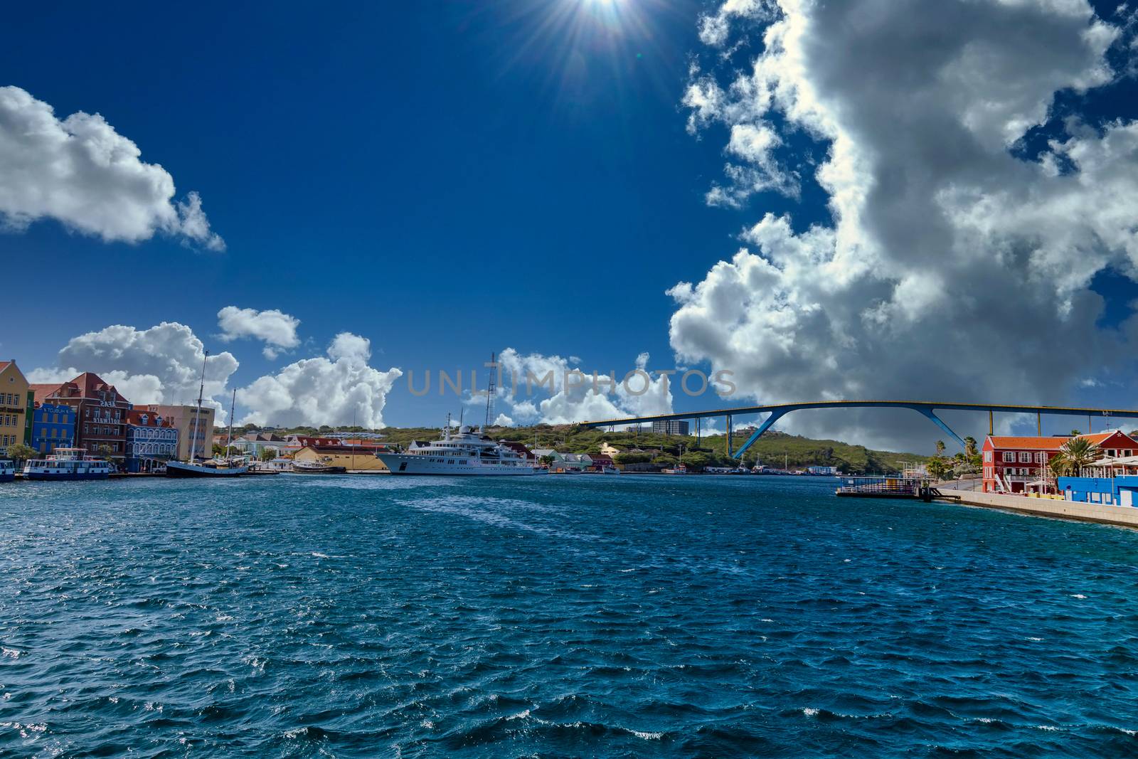 Massive luxury yacht docked near bridge on Curacao