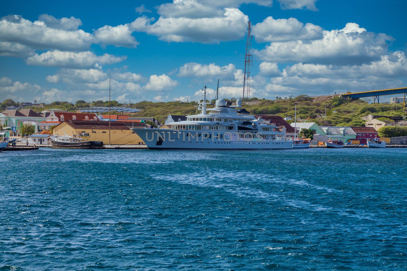 Massive luxury yacht docked near bridge on Curacao