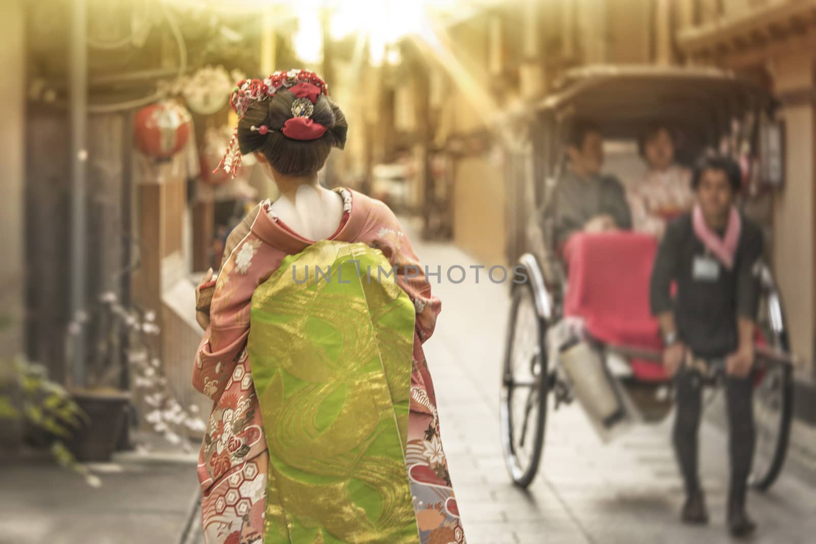 Maiko walking in an alley of Kyoto in the sunset light by kuremo