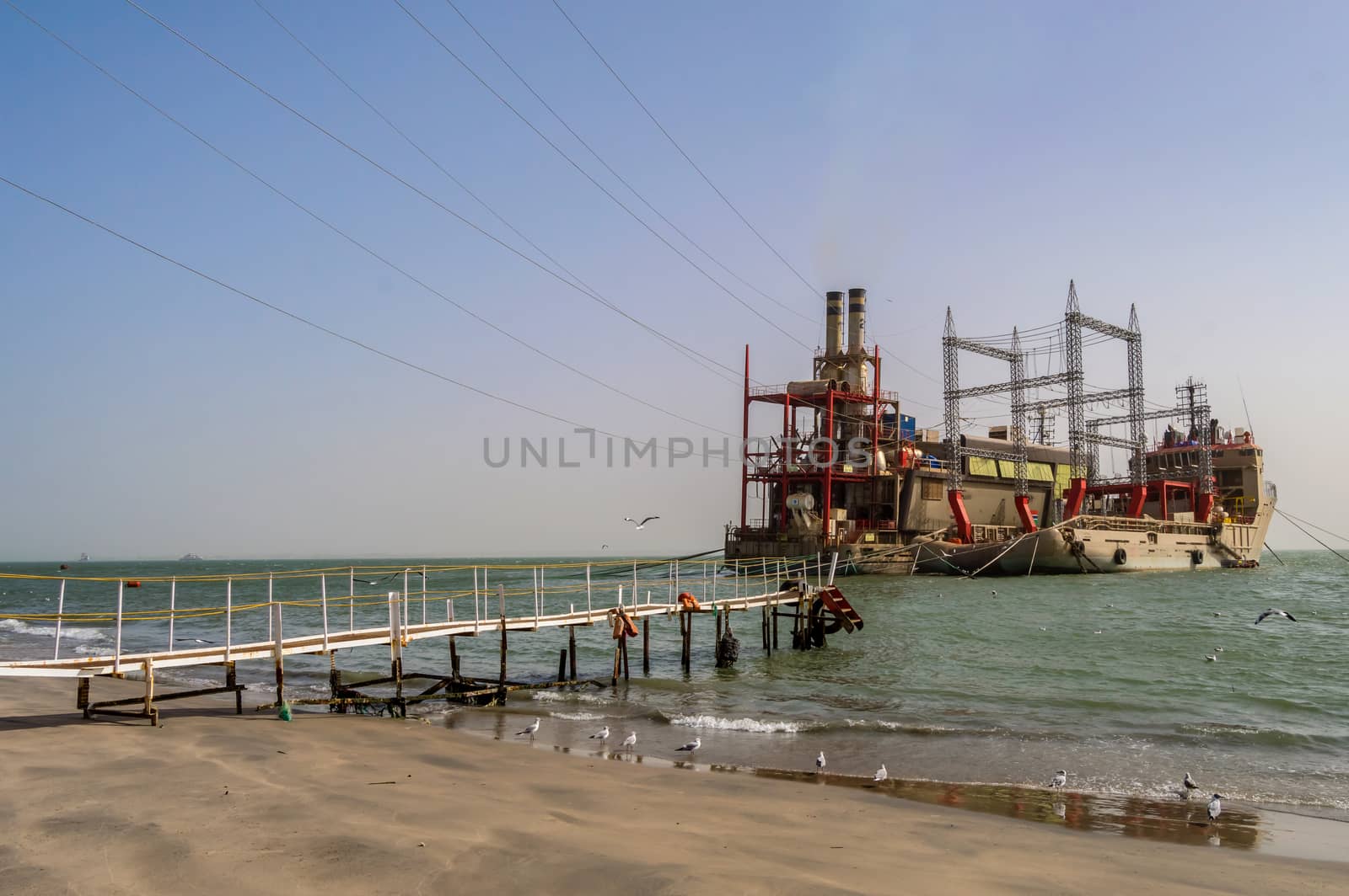 GAMBIA, BIJILO - 07 January 2020: Power plant on moored boats near Banjul beach in The Gambia