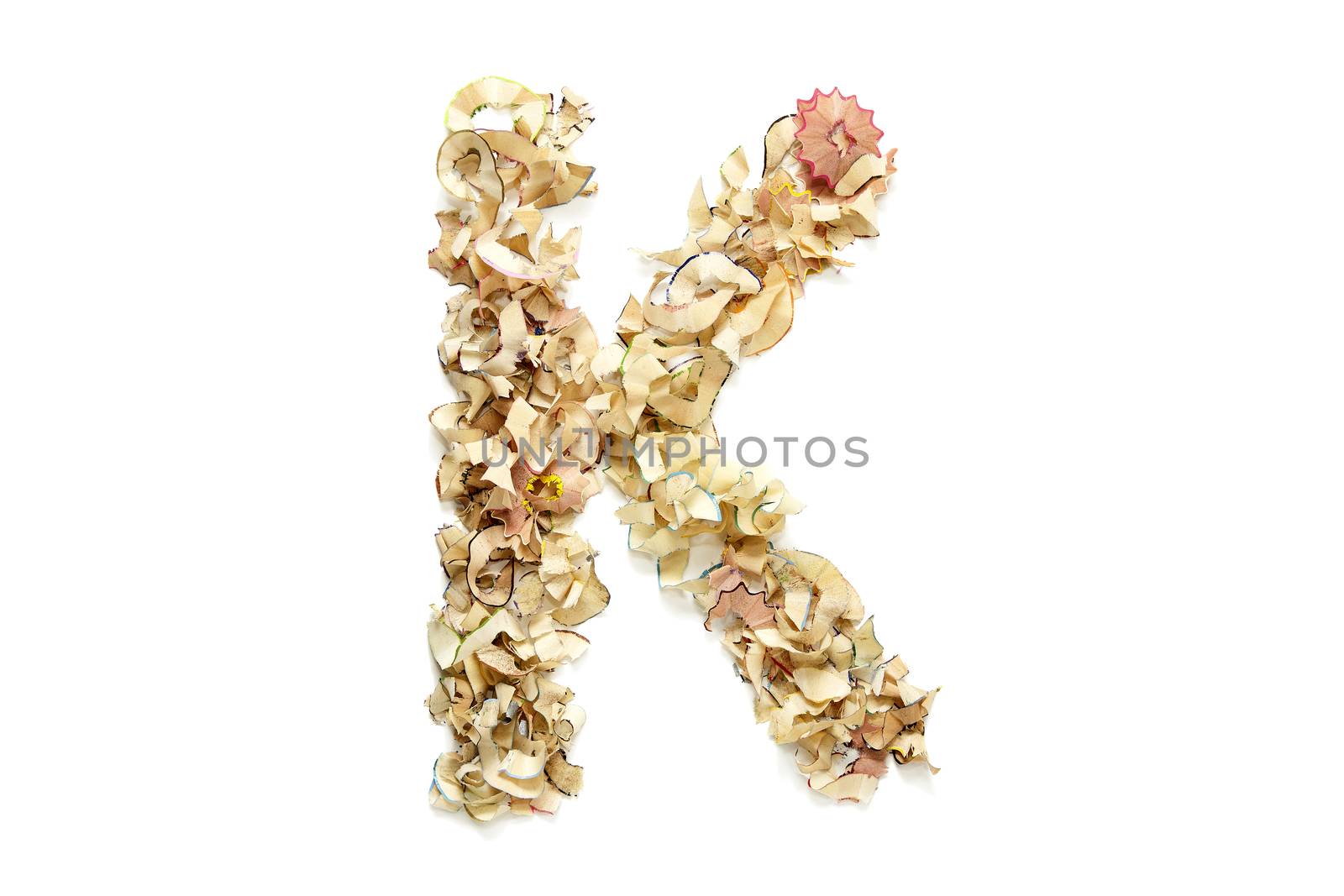 Letter K made from coloured pencil shavings for use in your design.