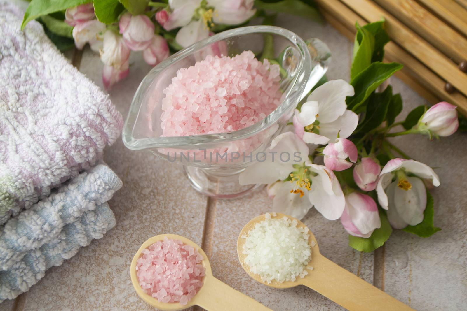 composition of spa treatment on wooden background. Concept spa background with salt and cherry or apple flower
