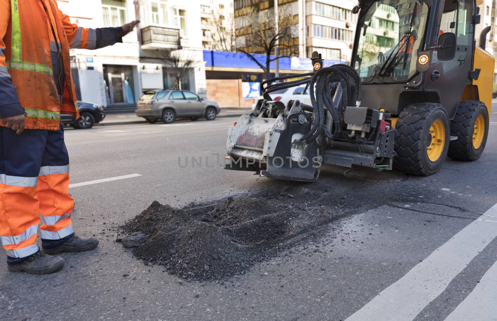 On a city road the tractor with a nozzle for repair of damages on asphalt was unloaded
