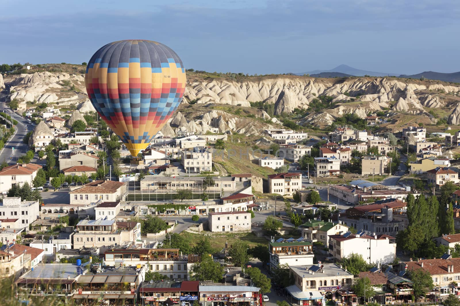 08.05.2018. Cappadocia, Turkey. A view of a colorful balloon flying over the town of Goreme at dawn.