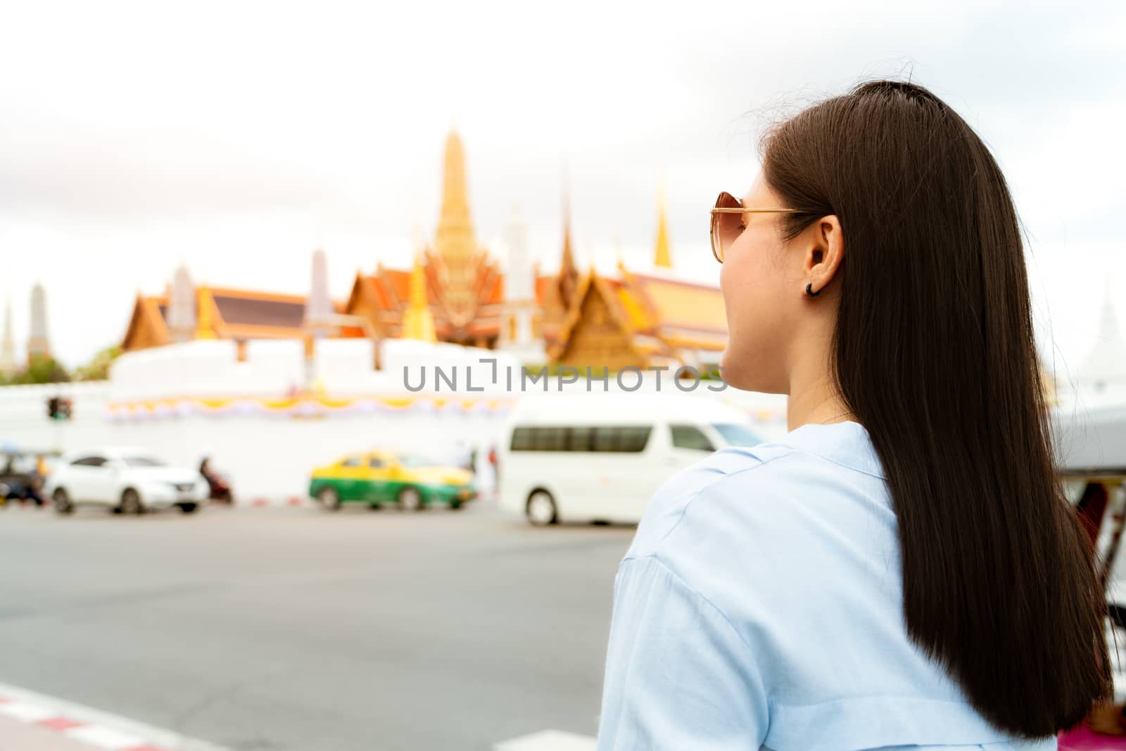 Young Woman traveling to Grand palace and Wat phra keaw at sunset at Bangkok, Thailand