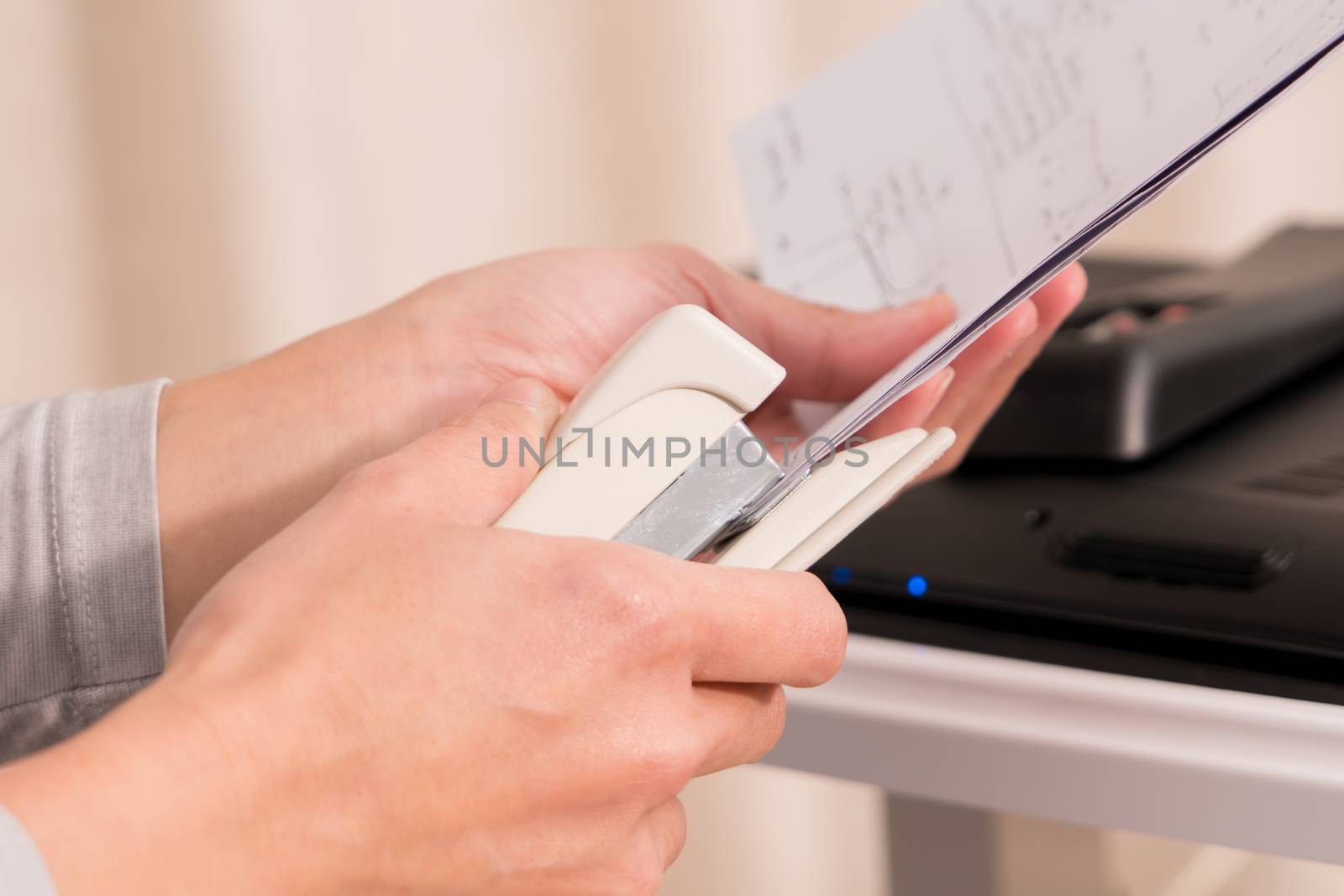 focus on the women hand stapling the hand writing paper, working and office concept