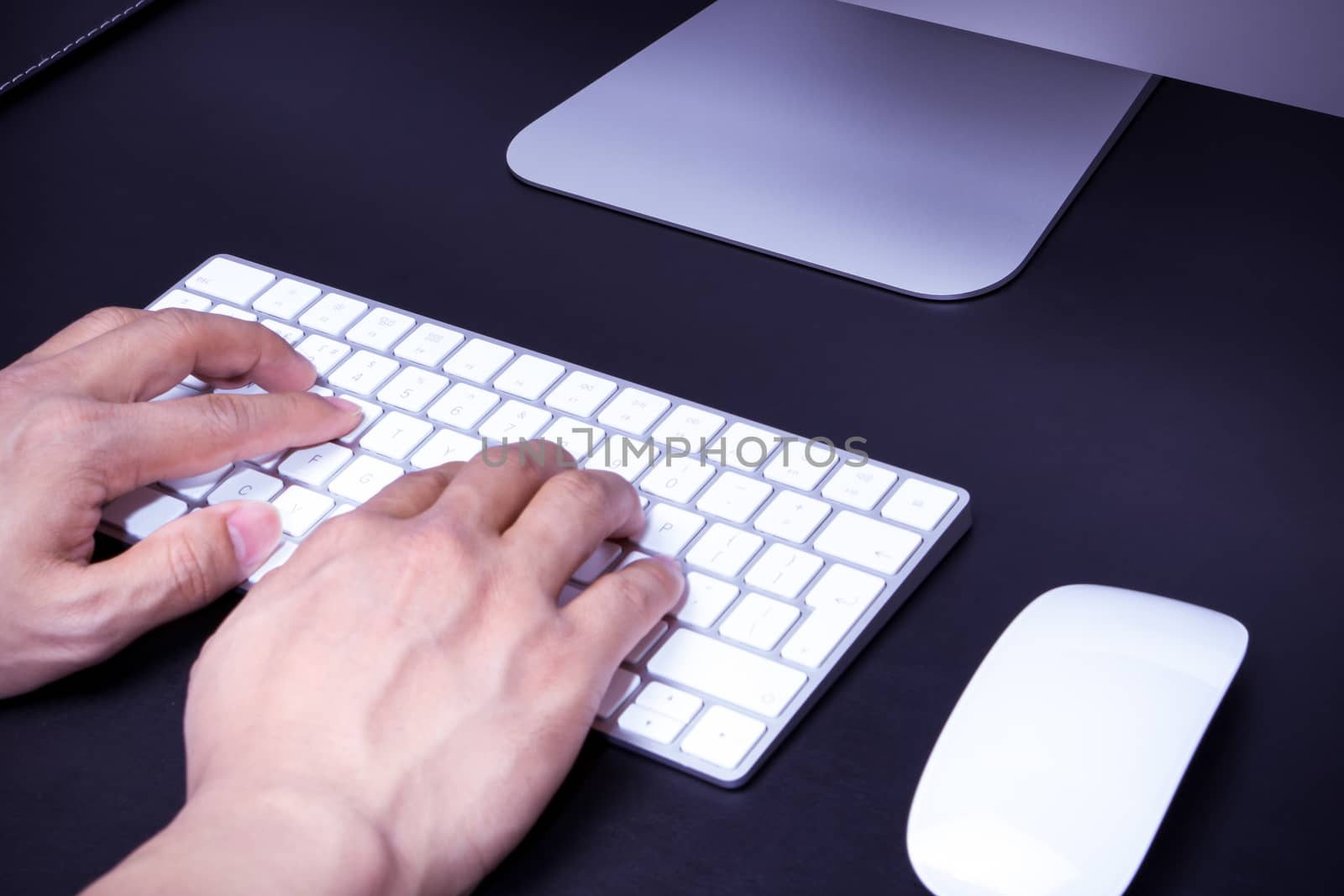 focus on the men hand on the white keyboard and mouse