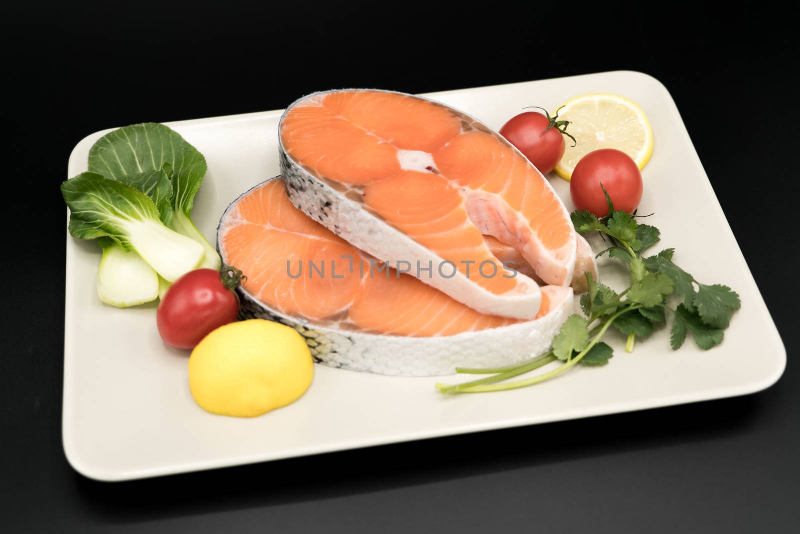 raw salmon steak with vegetable on plate, food and vegetable concept