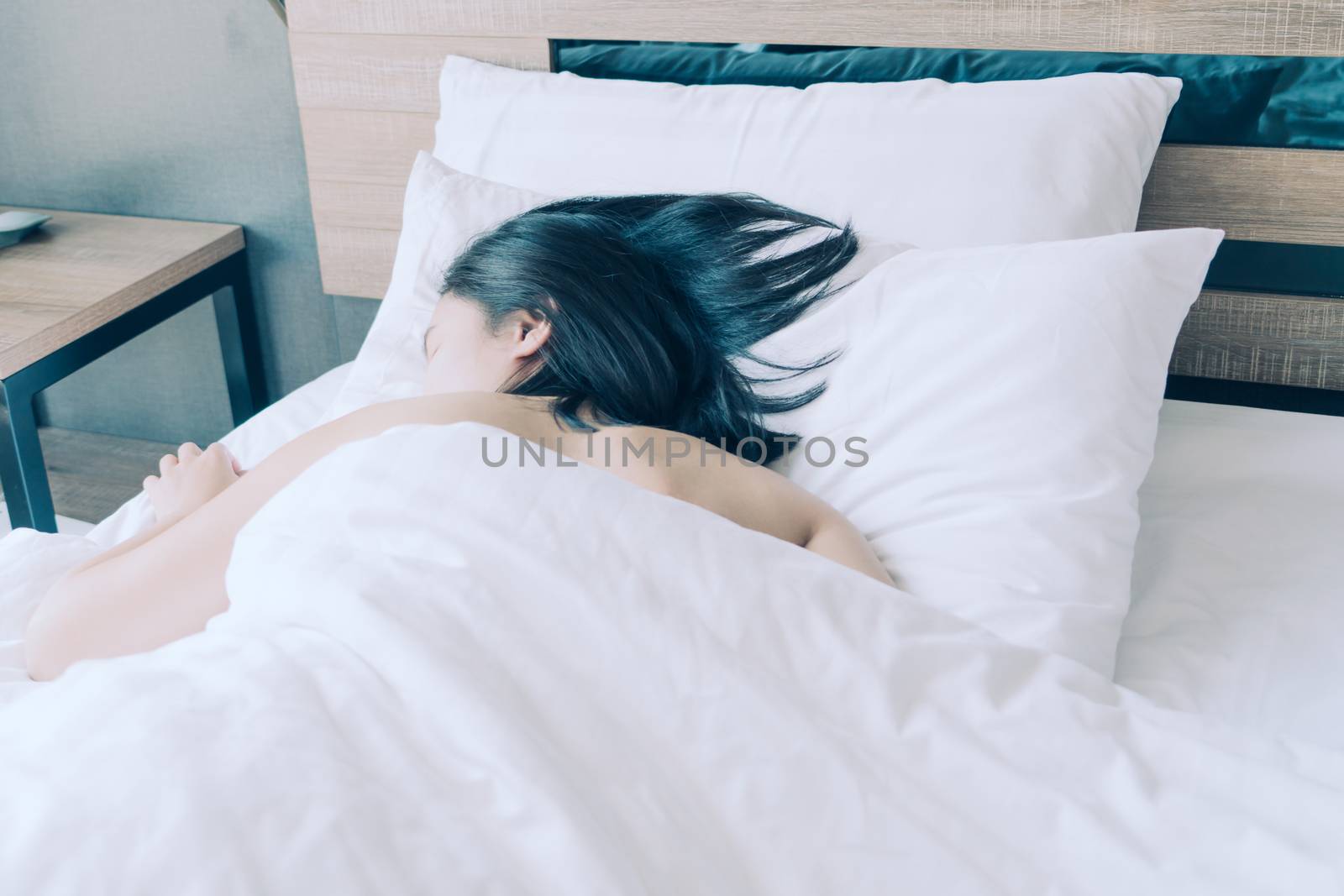 women sleep in white pillow on bed