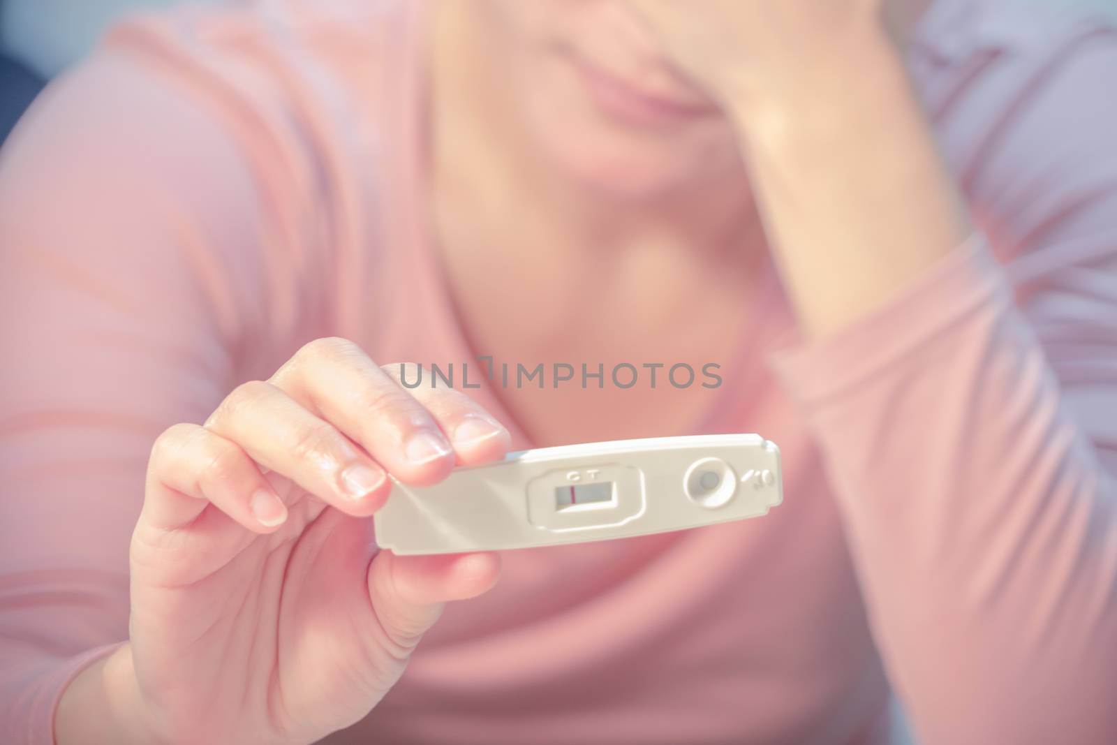 soft focus on the negative pregnancy test result hold on sad women hand