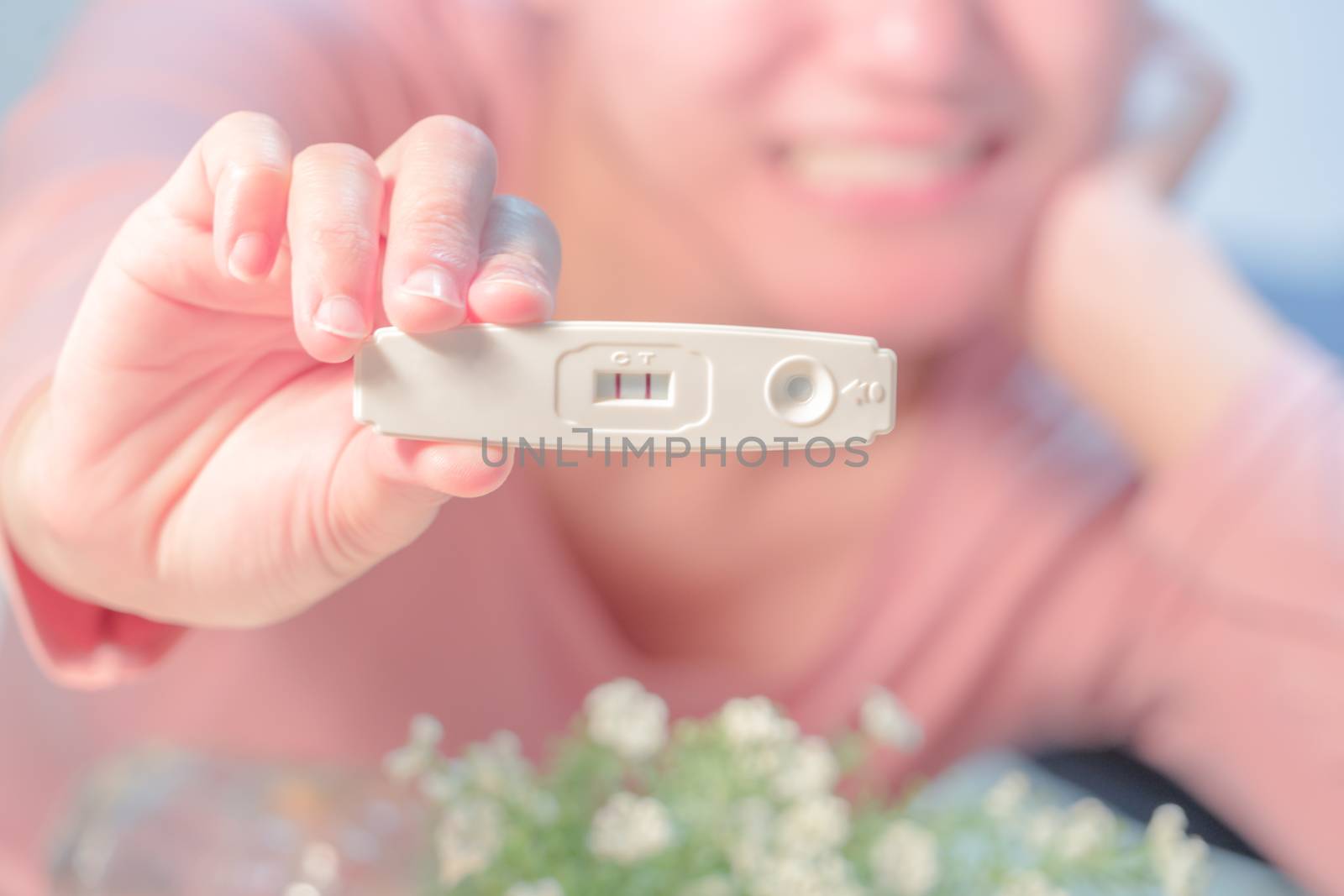 focus on the positive pregnancy test result hold on happy women hand