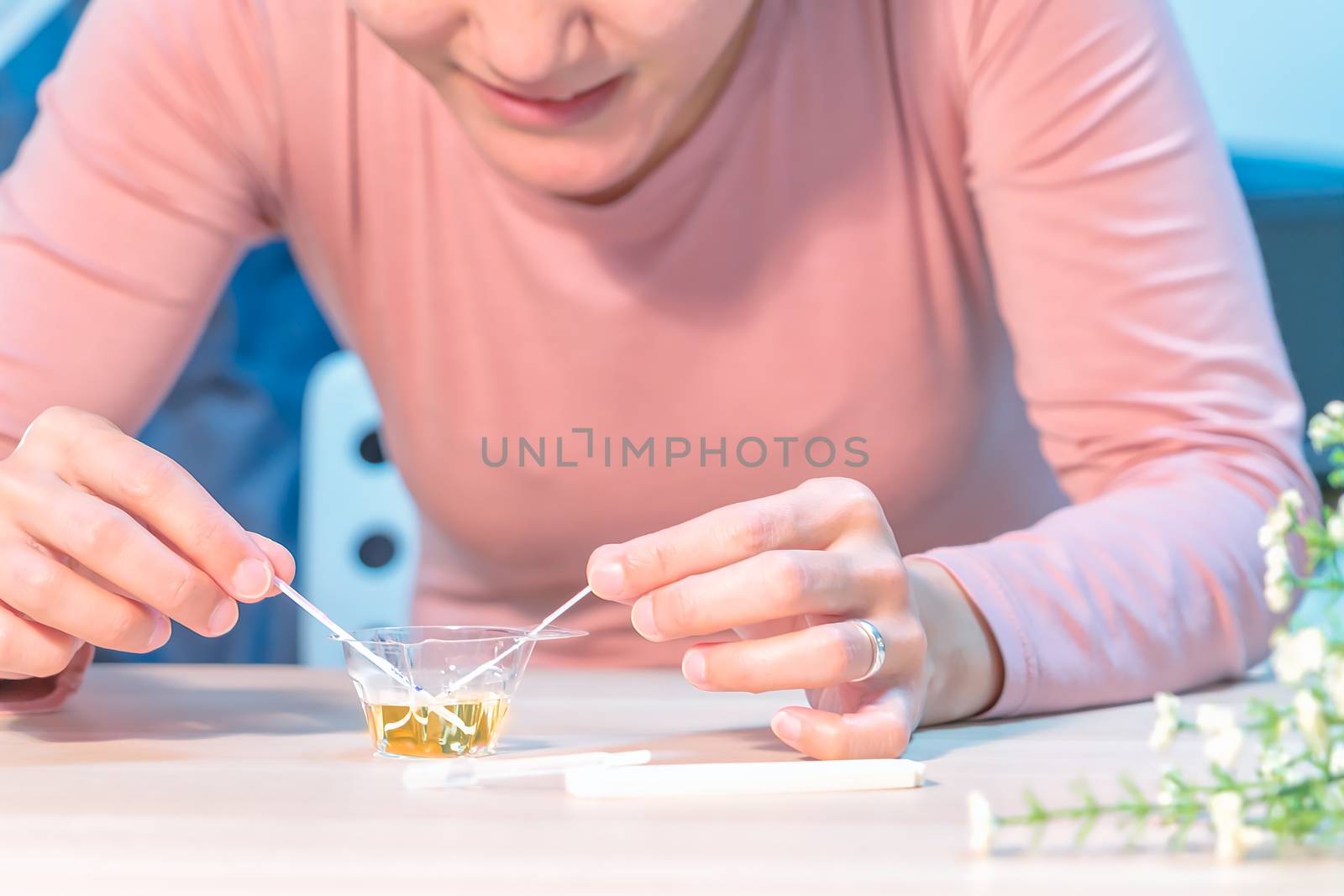 the happy women hand put the pregnancy test pad to the urine and waiting for the result