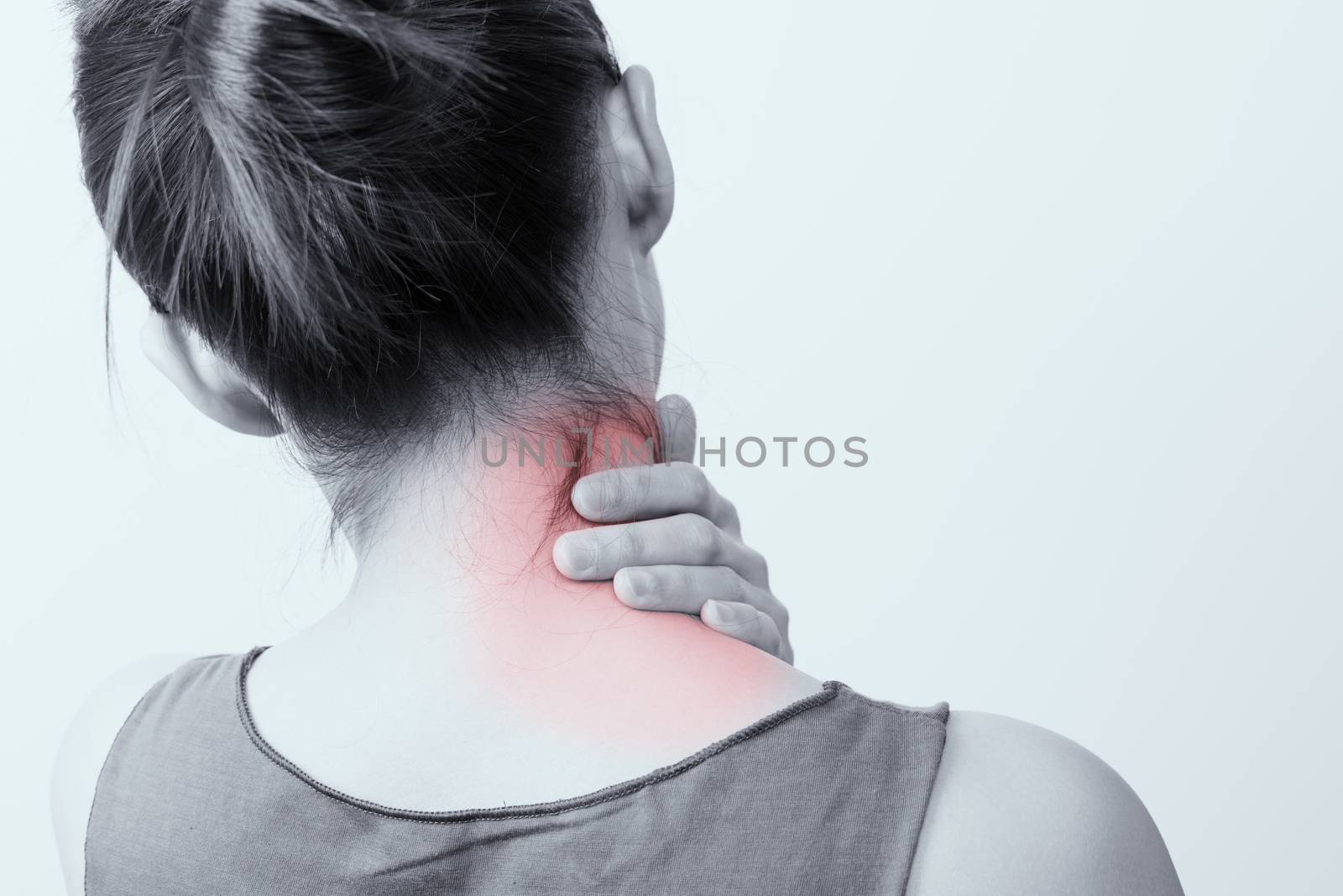 closeup women neck and shoulder pain/injury with red highlights on pain area with white backgrounds, healthcare and medical concept - B&W filter