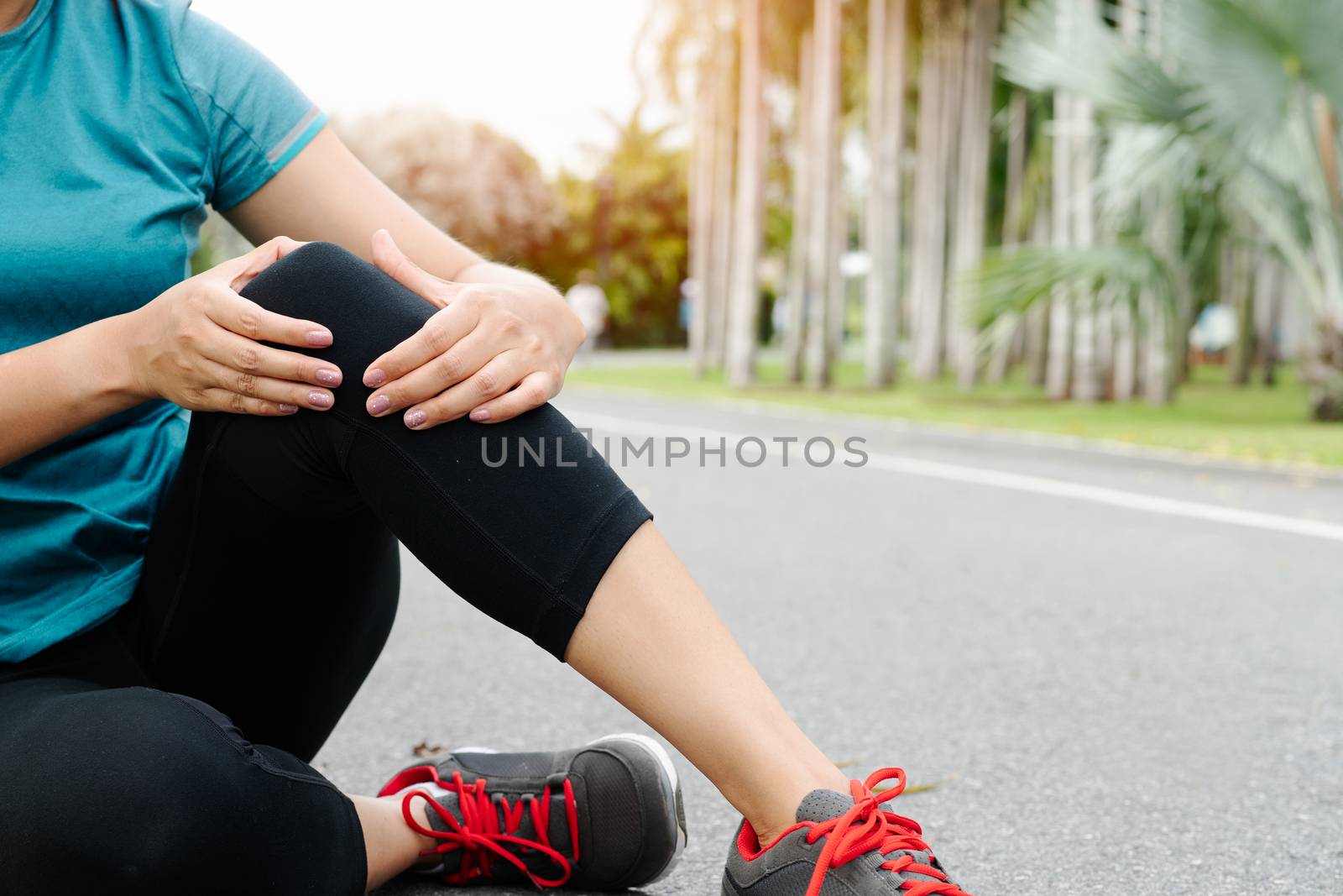 fitness woman runner feel pain on knee. Outdoor exercise activit by psodaz