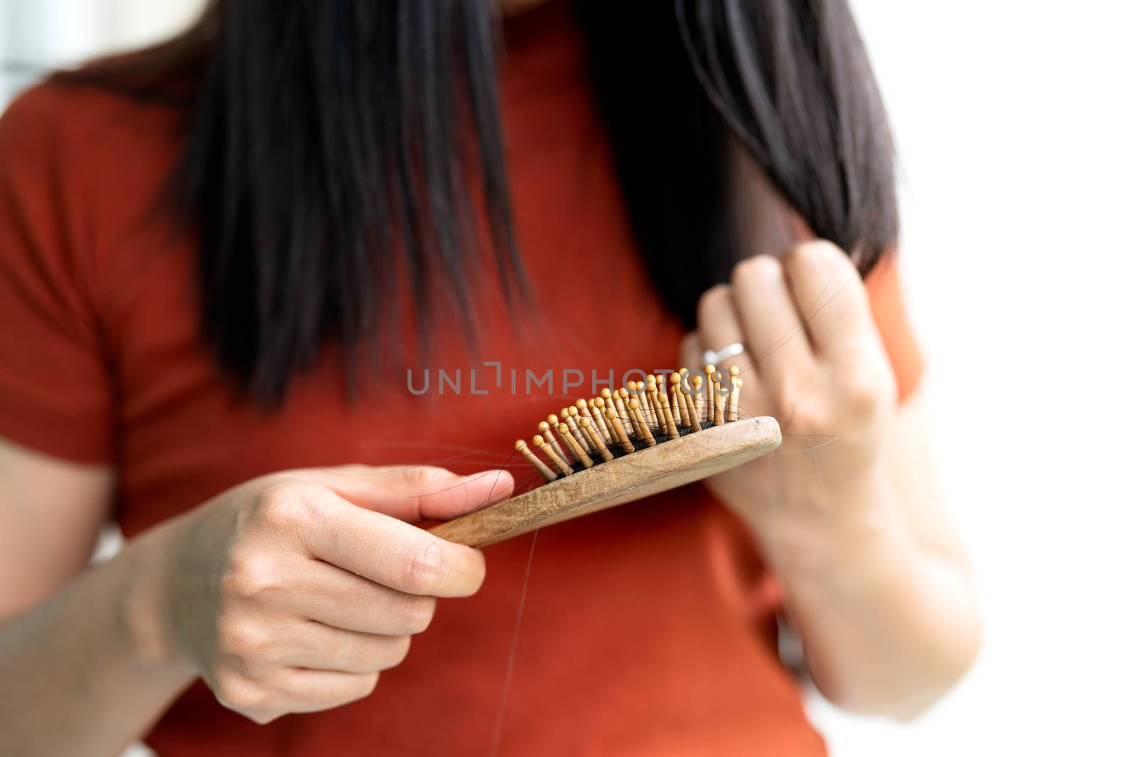 long loss hair fall on woman brush with and woman looking at her hair