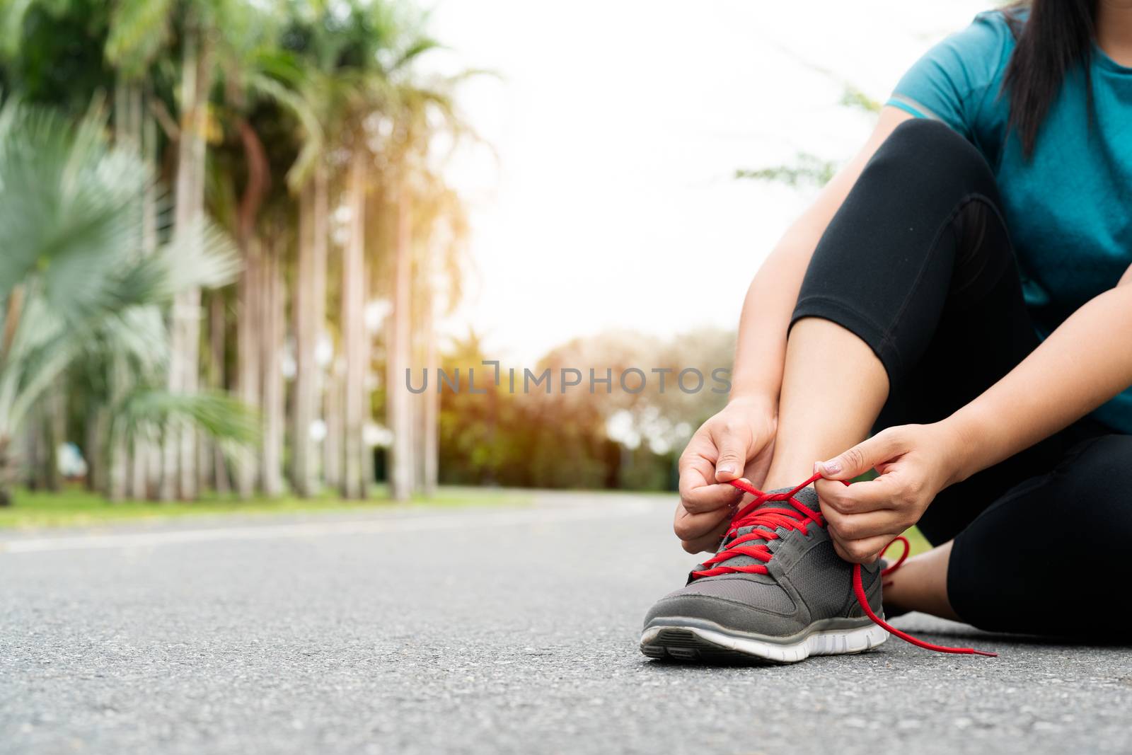 sport woman tying shoelace before running, outdoor activities by psodaz