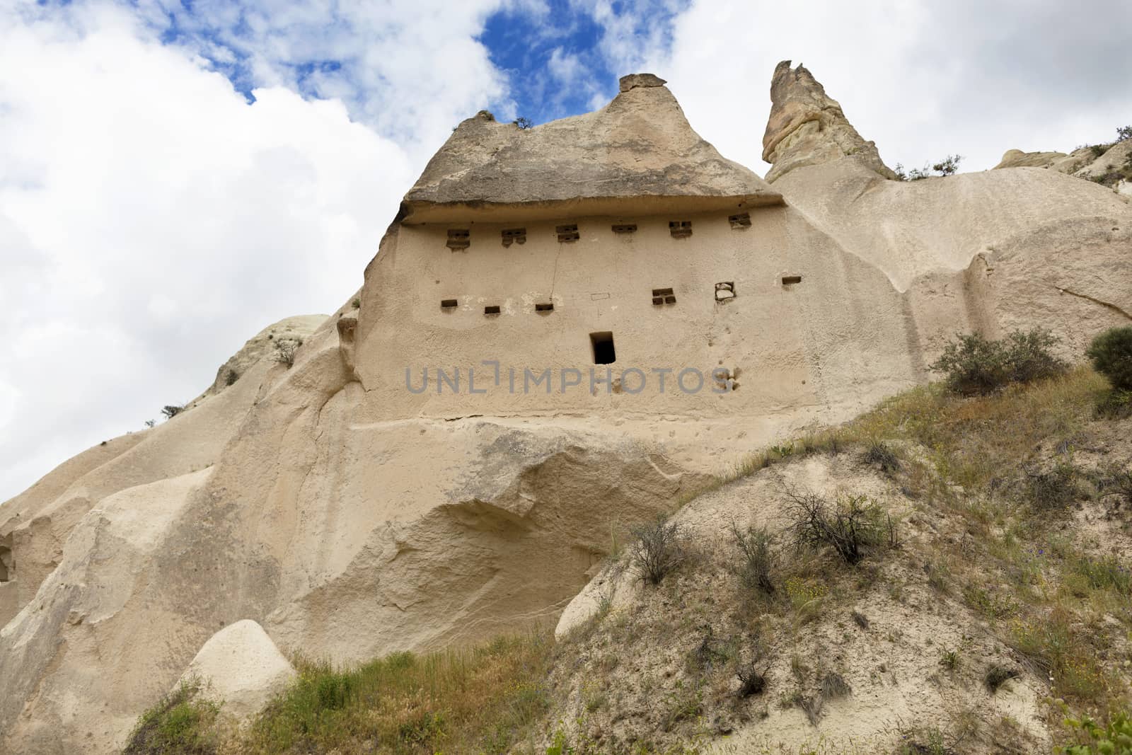 Abandoned caves in the Cappadocia mountains against the blue sky