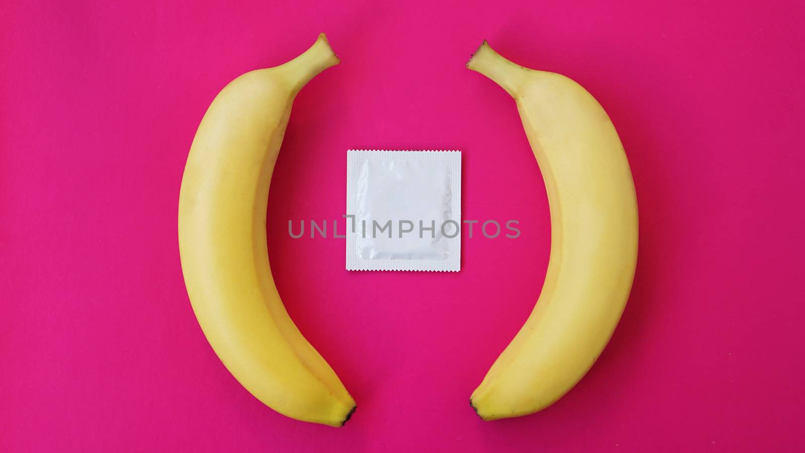 Condoms and two bananas together, the concept of contraceptives and the prevention of venereal diseases of same-sex marriage.