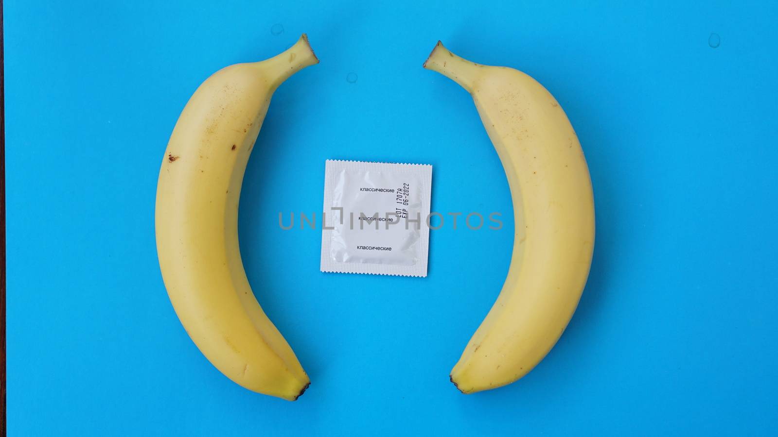 Condoms and two bananas together, concept of contraceptives and the prevention by natali_brill
