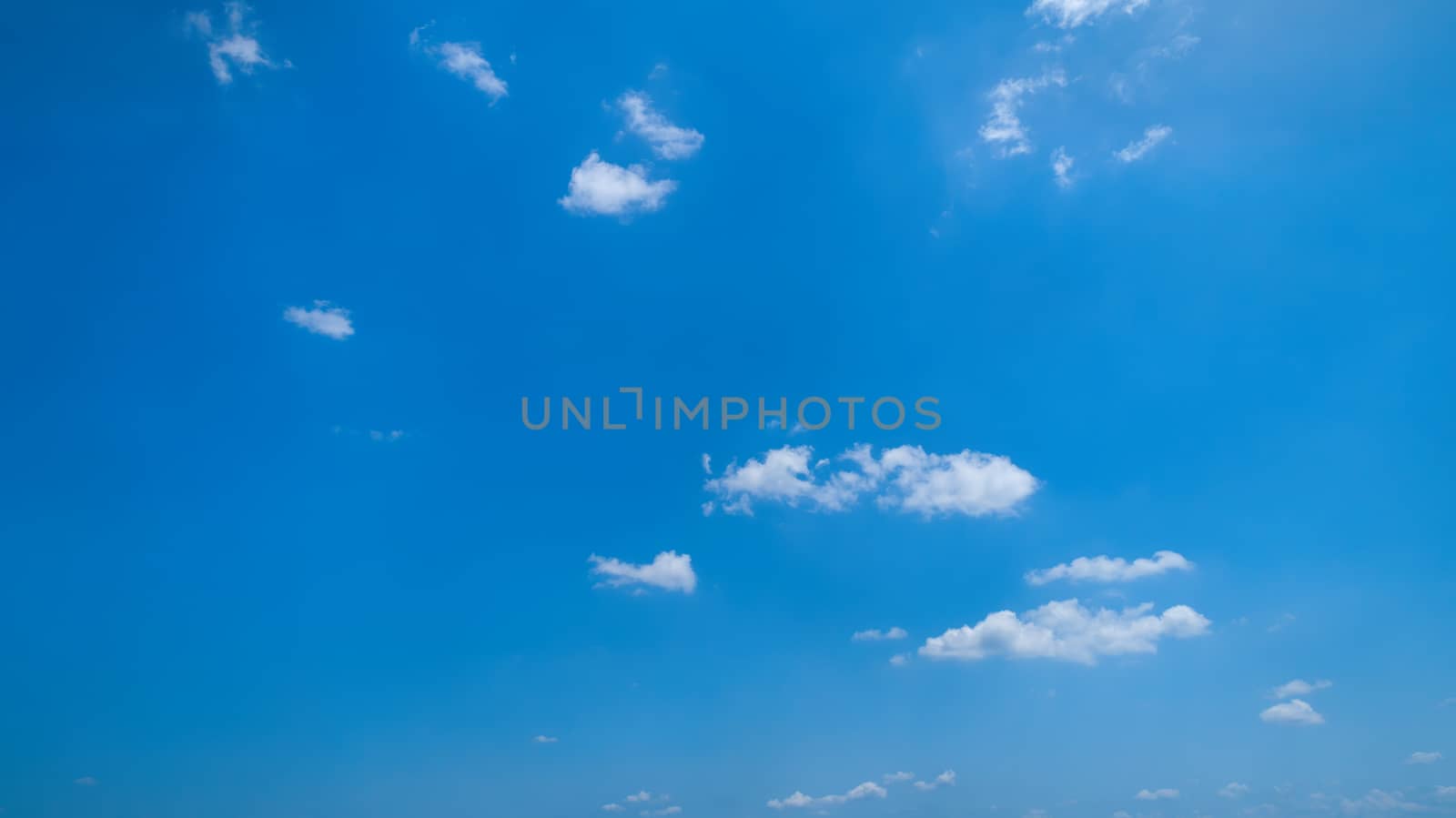White Fluffy Clouds Floating in the Bright Blue Skies on a Summer Day
